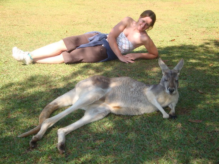 Solo female traveler posing beside a kangaroo in Australia during one of her first international backpacking trips.