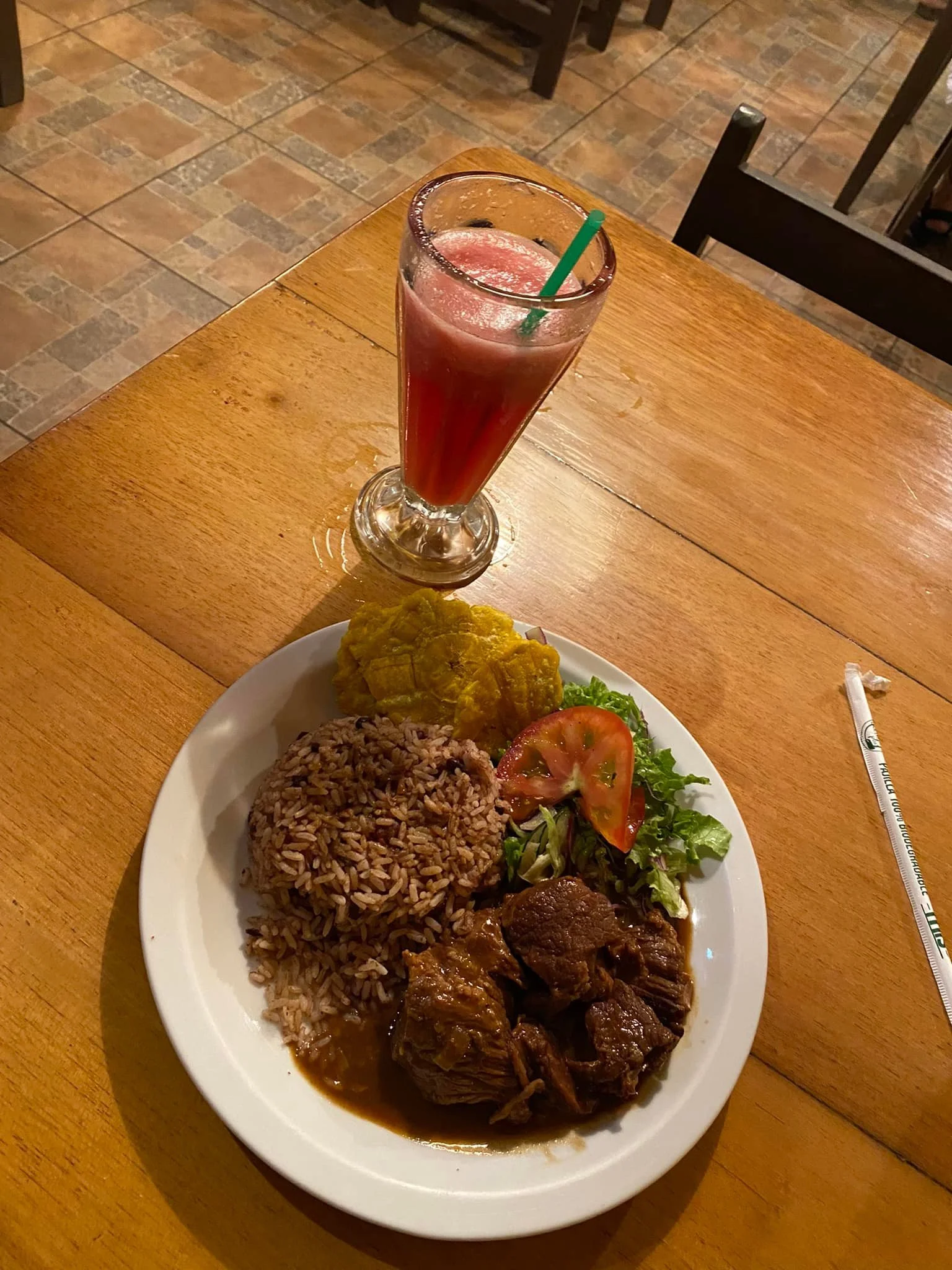 Traditional Costa Rican meal with rice, beans, plantains, salad, and meat served at a local soda.