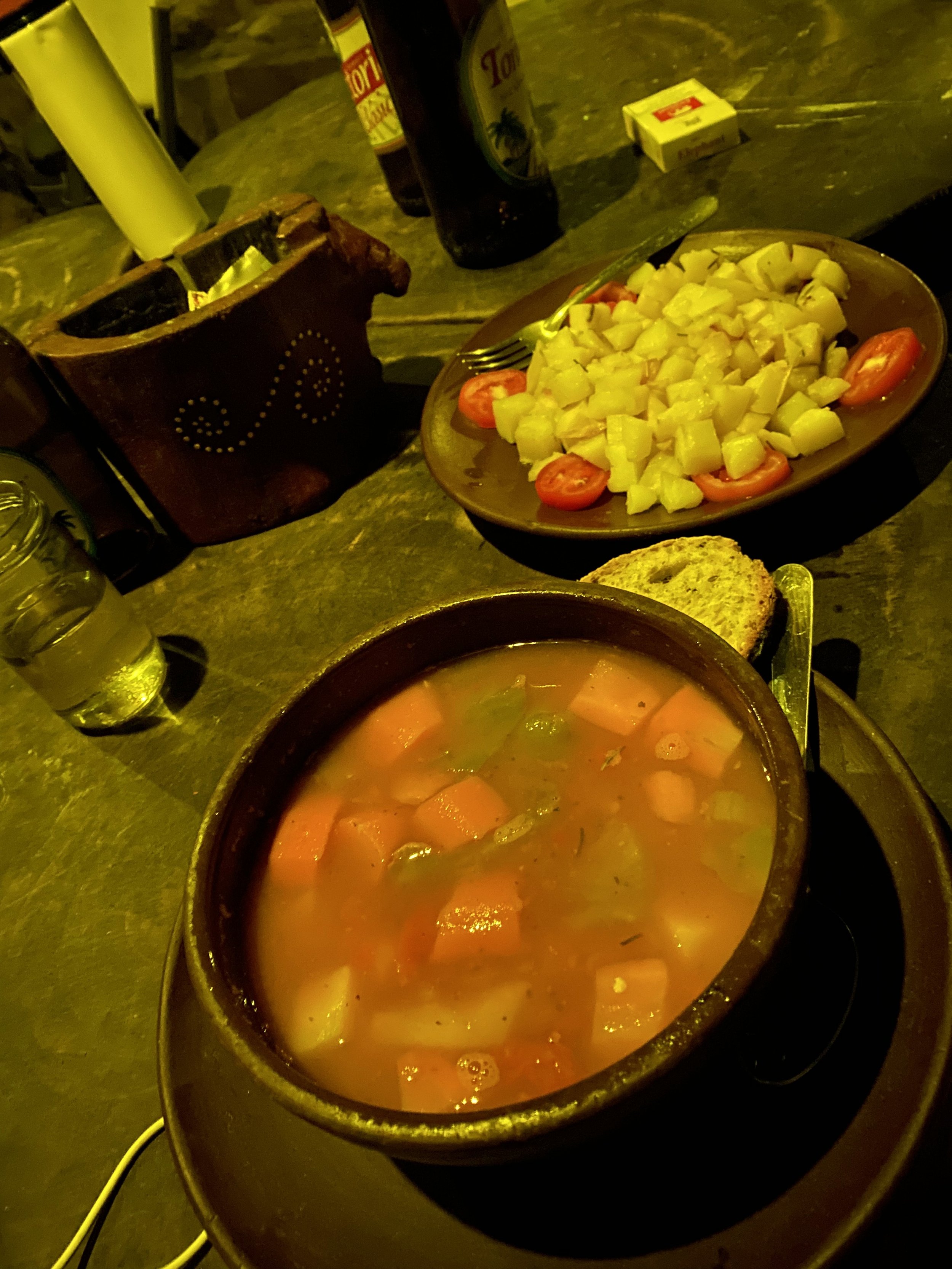 Rustic meal of soup, bread, and local food served at an off-grid hostel on Ometepe Island, Nicaragua.