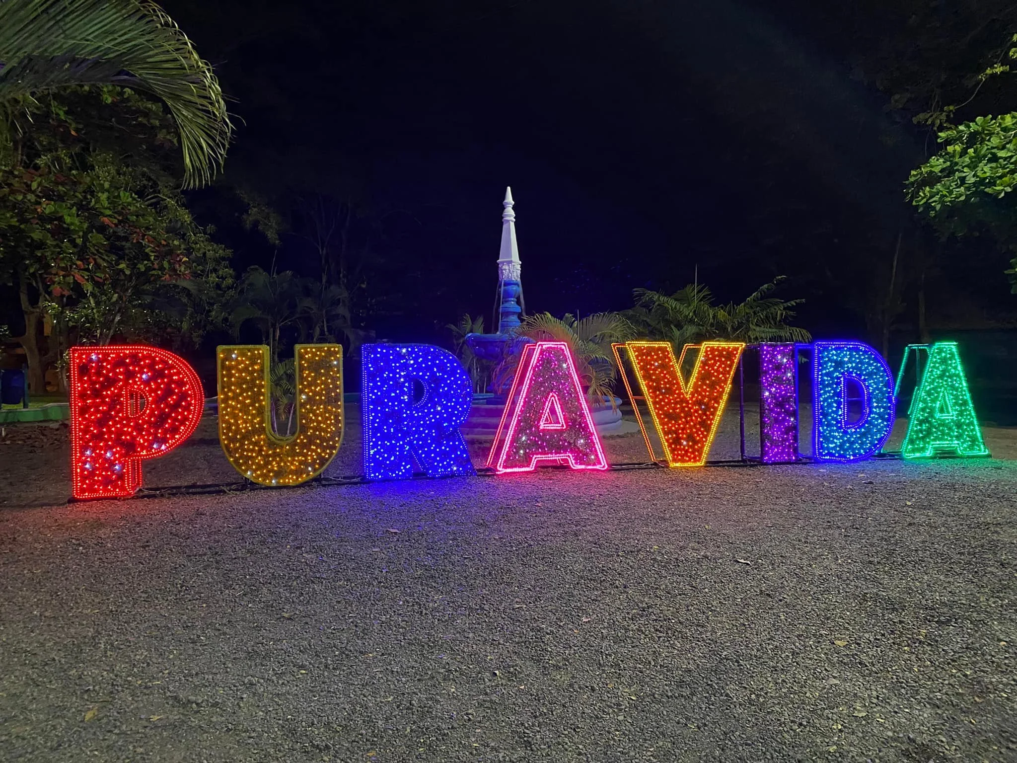 Colorful illuminated Pura Vida sign at night in Costa Rica.