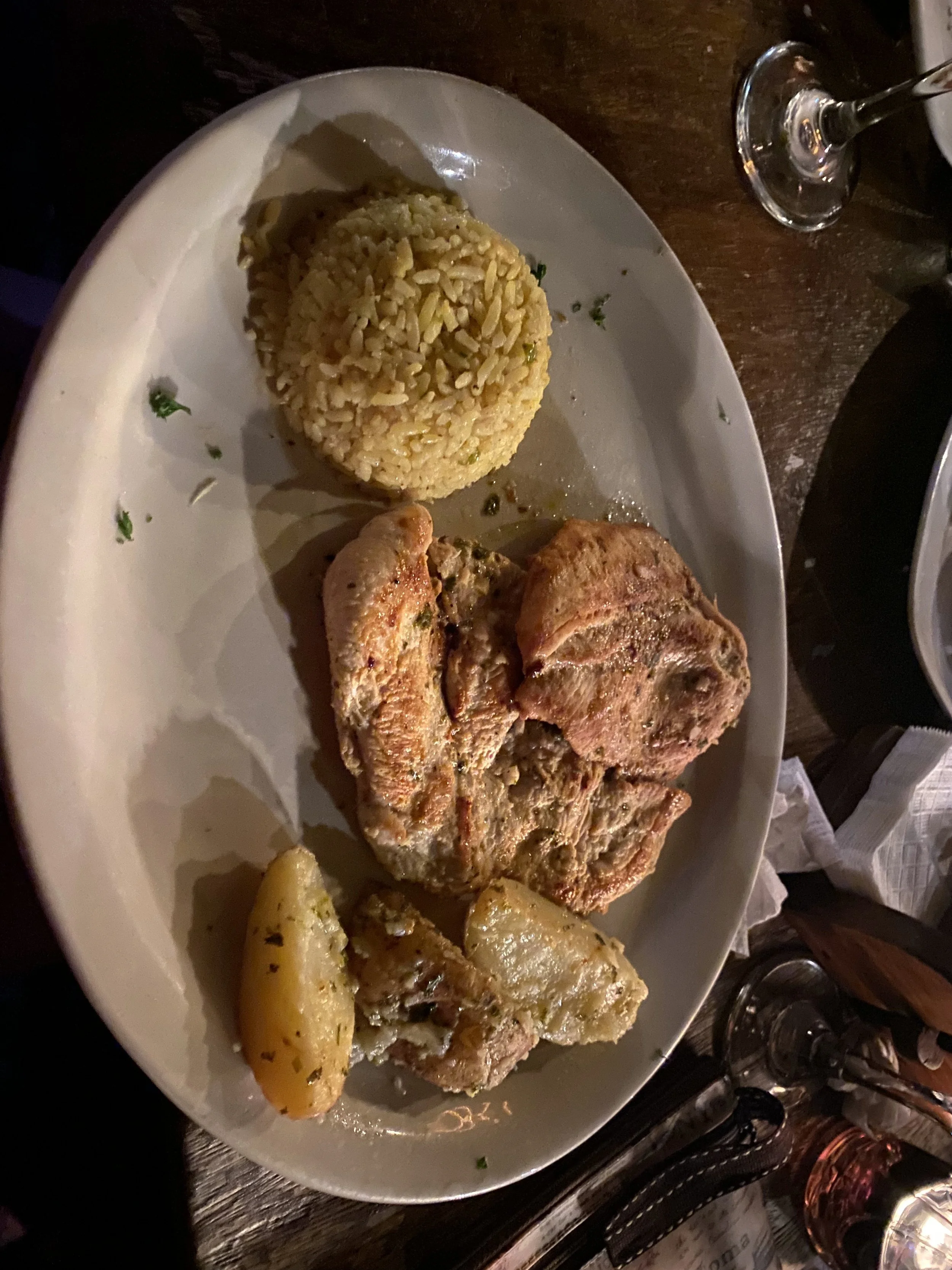 Plate of grilled chicken with rice and potatoes at a beachside restaurant in Las Peñitas, Nicaragua.