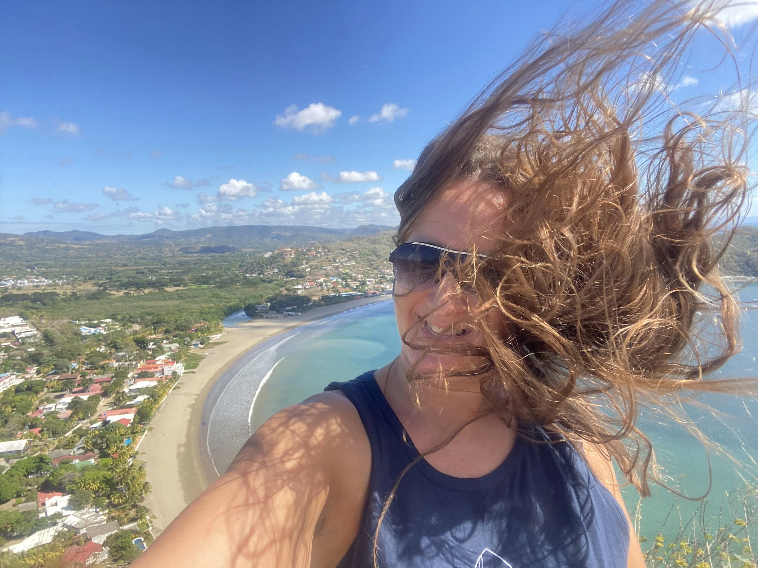 Windblown selfie at Cristo de la Misericordia overlooking the bay and coastline of San Juan del Sur, Nicaragua.