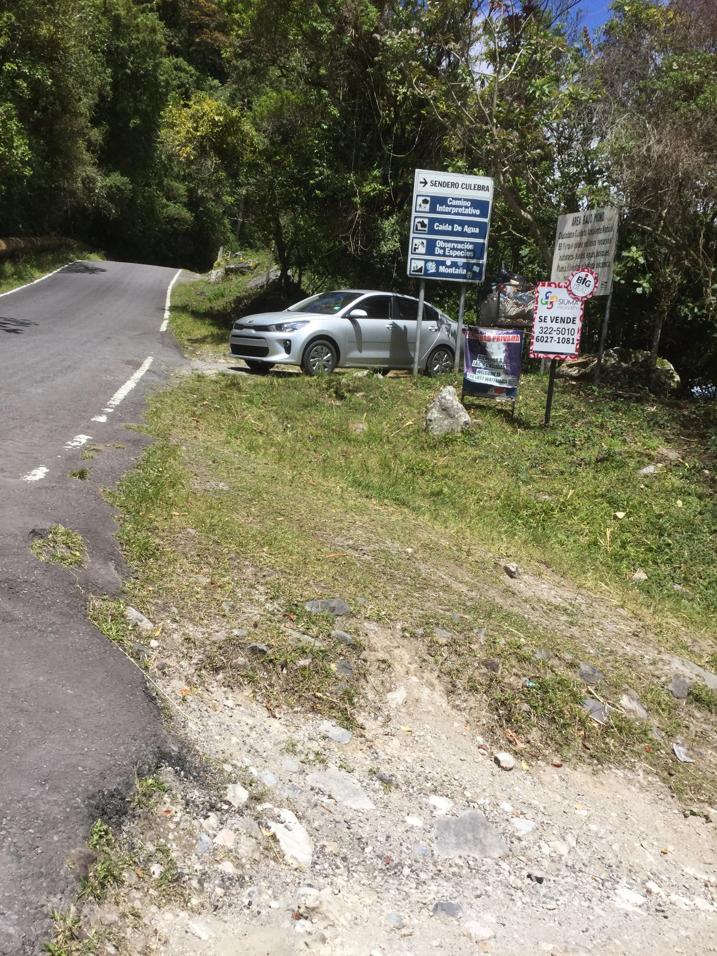Roadside signs marking the entrance to the Lost Waterfalls Trail near Boquete, Panama.