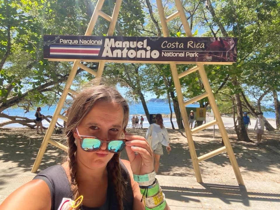 Solo traveler at the entrance to Manuel Antonio National Park in Costa Rica.