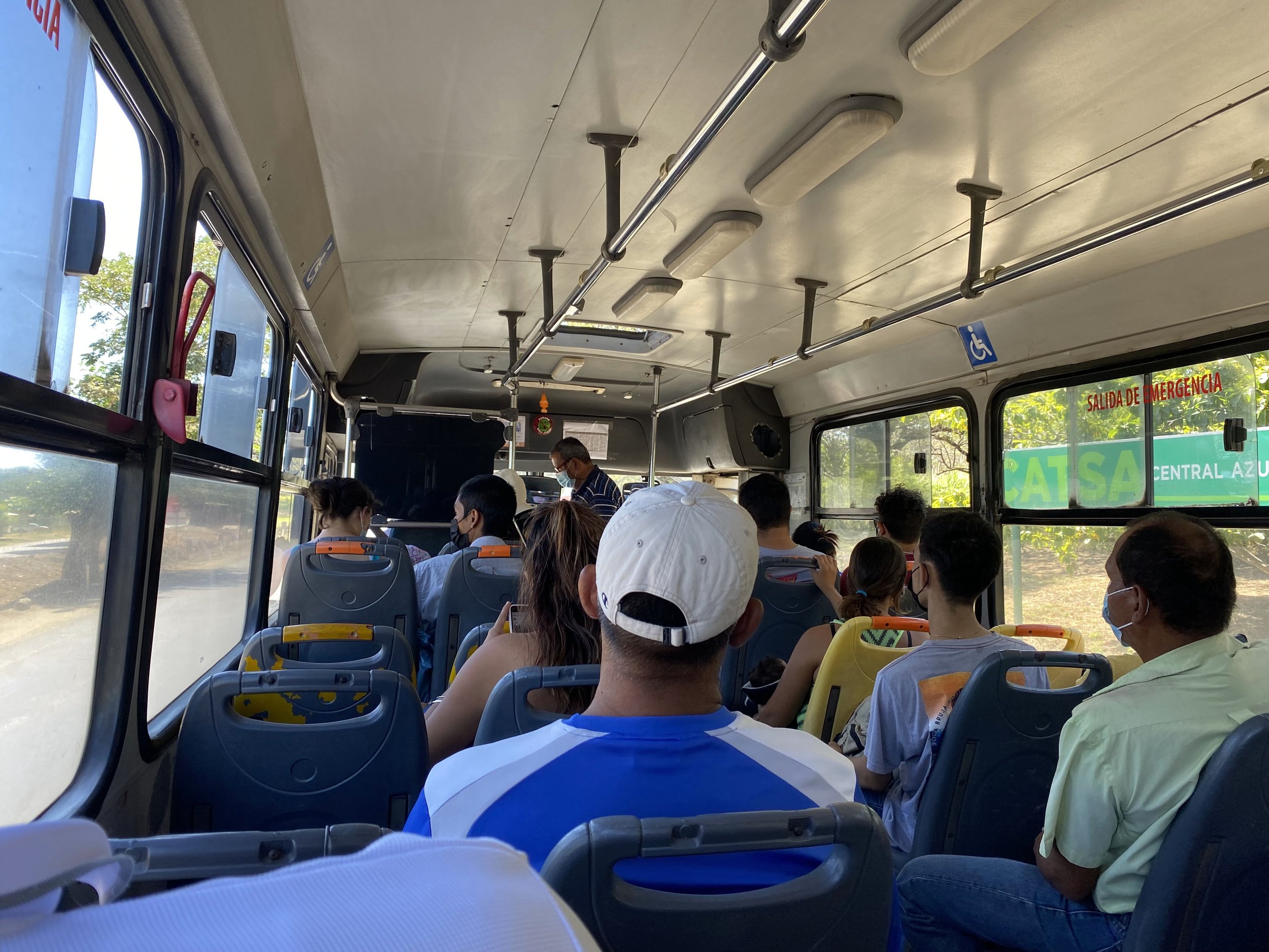 Passengers riding a local public bus in Costa Rica, highlighting an affordable transportation option for travelers.