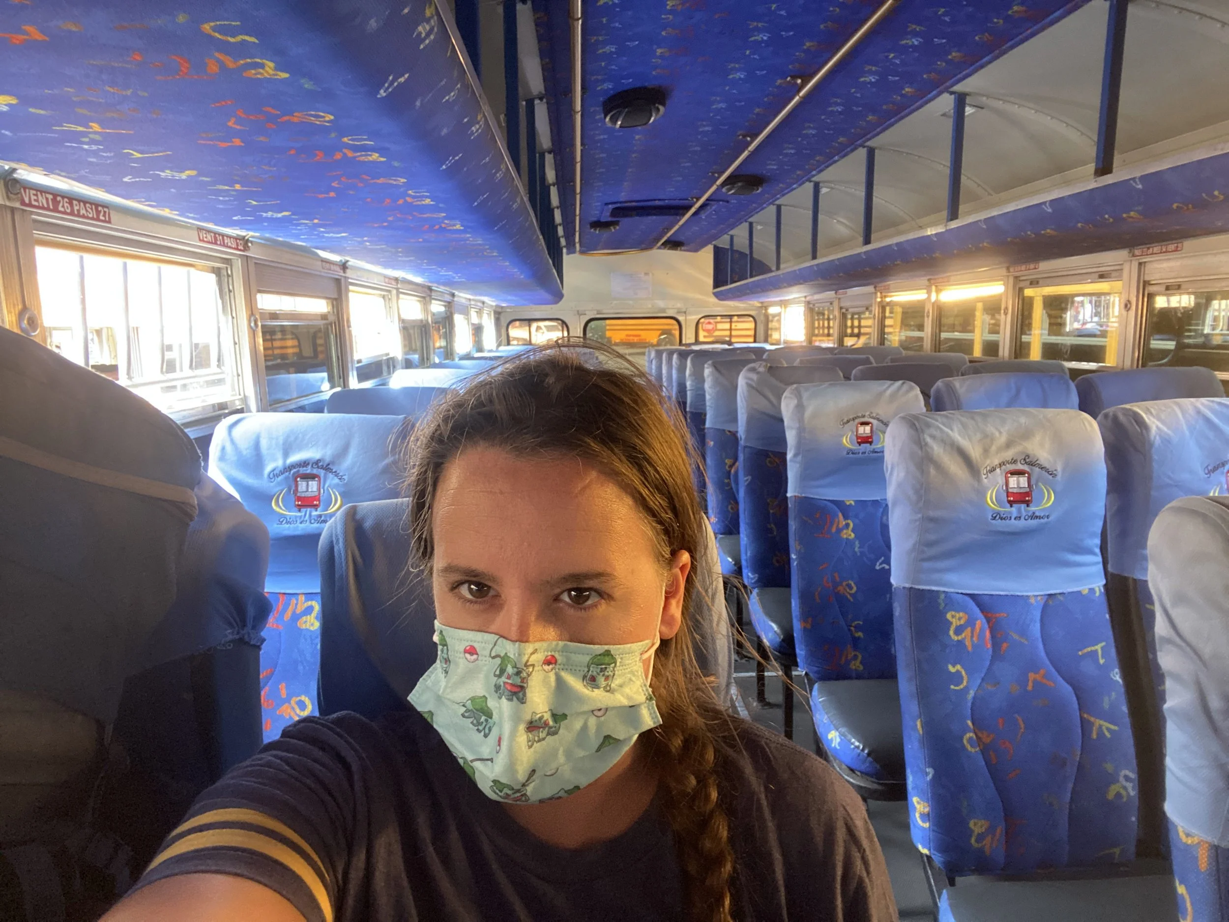 Solo traveler wearing a face mask sitting on a mostly empty bus traveling through Nicaragua