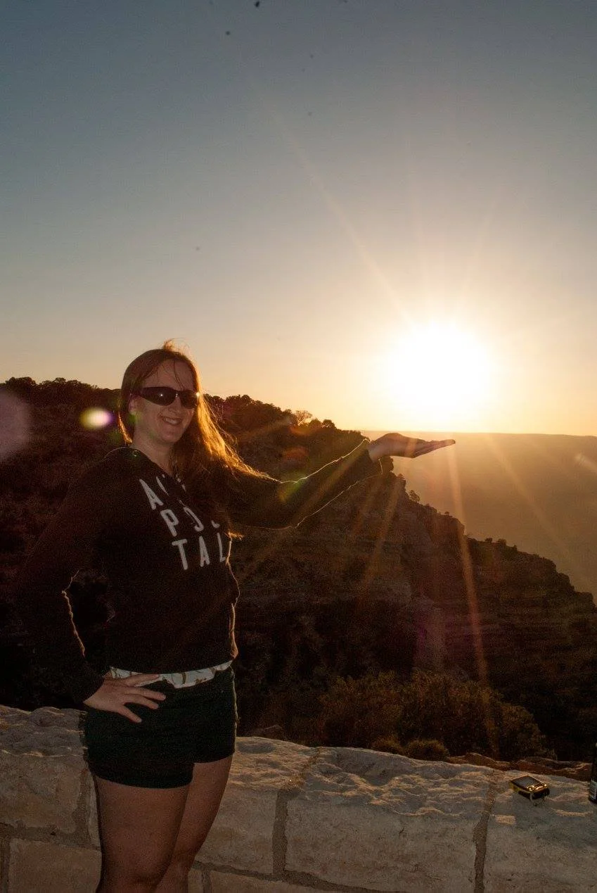 Traveler posing at sunset on the edge of the Grand Canyon during a milestone birthday trip.