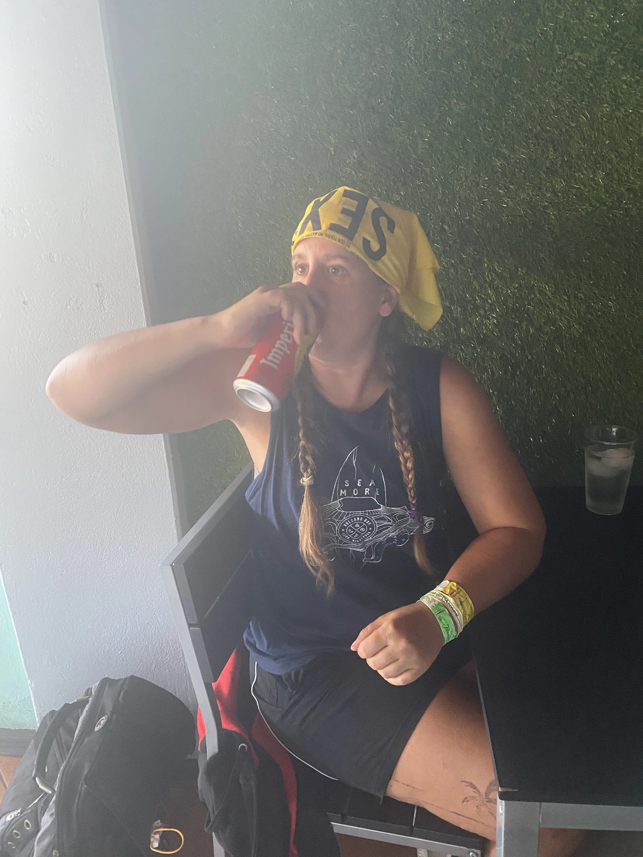 Traveller enjoying an Imperial beer after hiking in Rincón de la Vieja National Park, Costa Rica.