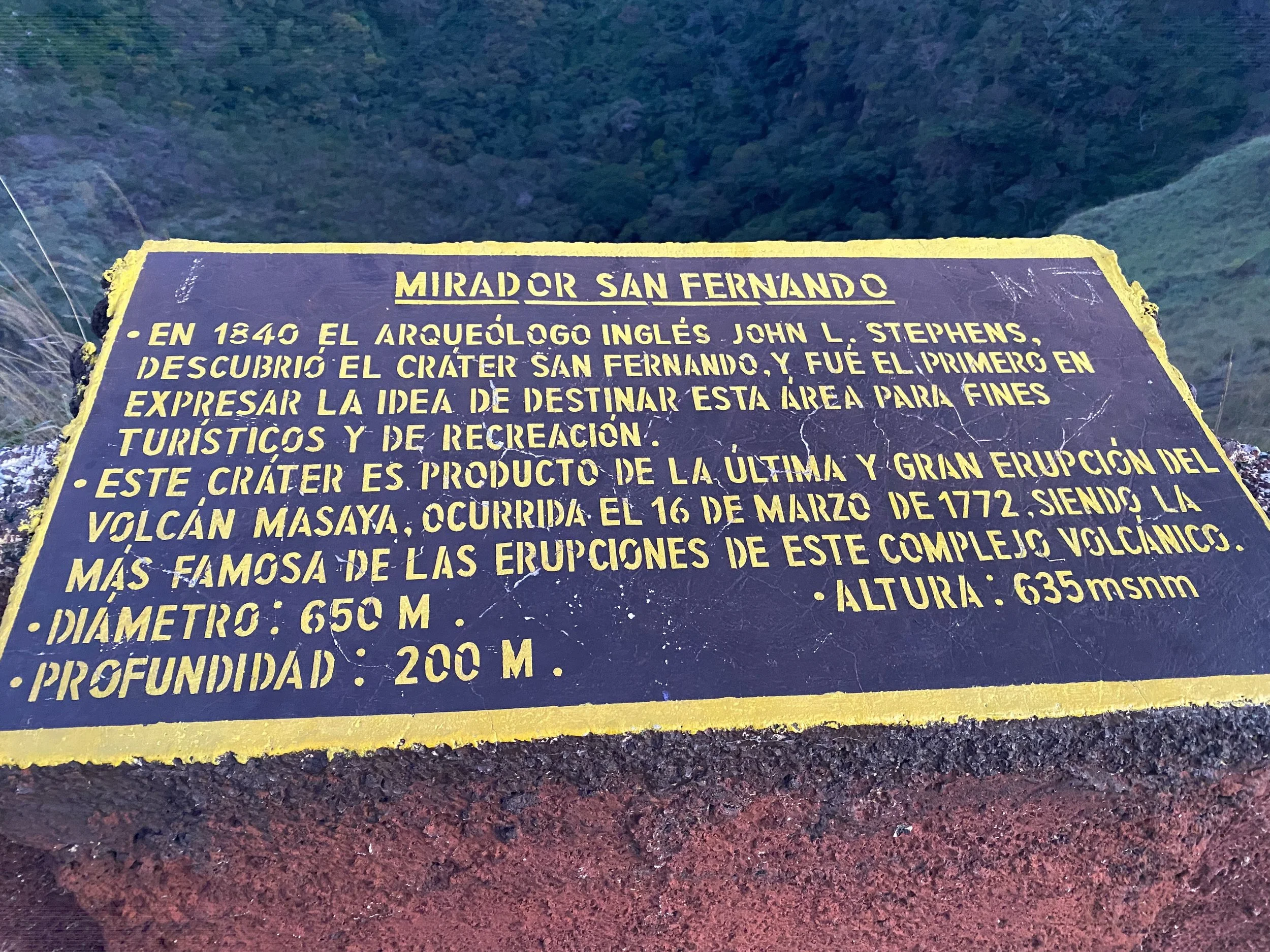 Informational sign at Mirador San Fernando viewpoint overlooking a volcanic crater in Nicaragua