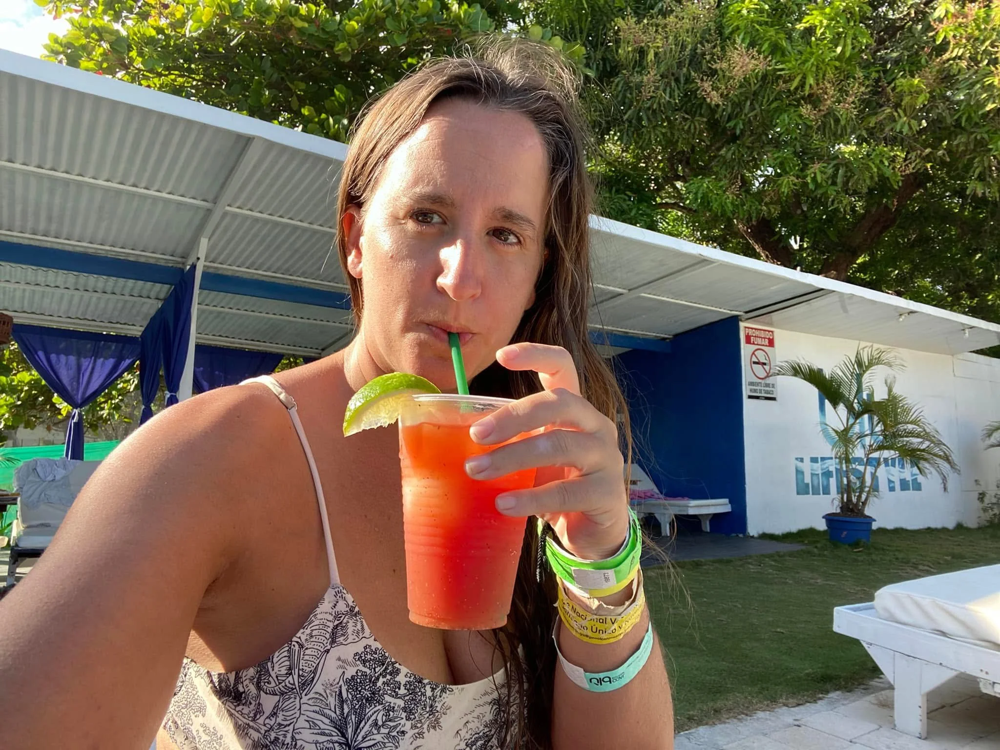 A traveller relaxing at Blu in Jacó, Costa Rica, enjoying a Bloody Mary beside the swimming pool on a sunny afternoon.