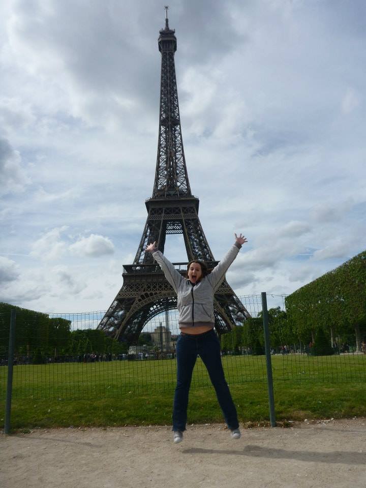 Jumping in front of the Eiffel Tower in Paris while celebrating a memorable travel experience and achieving a lifelong dream.