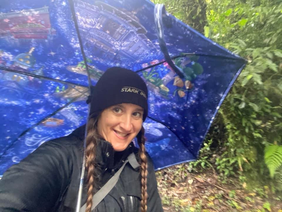Backpacker exploring Monteverde Cloud Forest in cool, rainy weather.