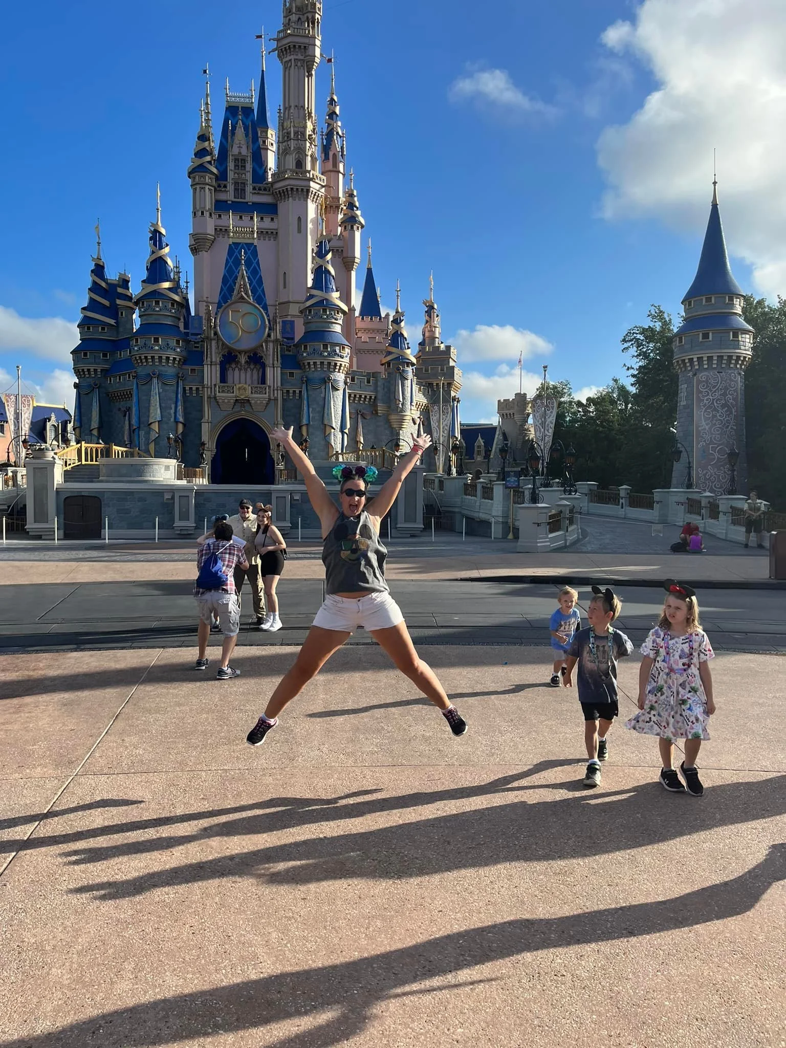 Traveler jumping in front of Cinderella Castle at Walt Disney World while celebrating a birthday trip.
