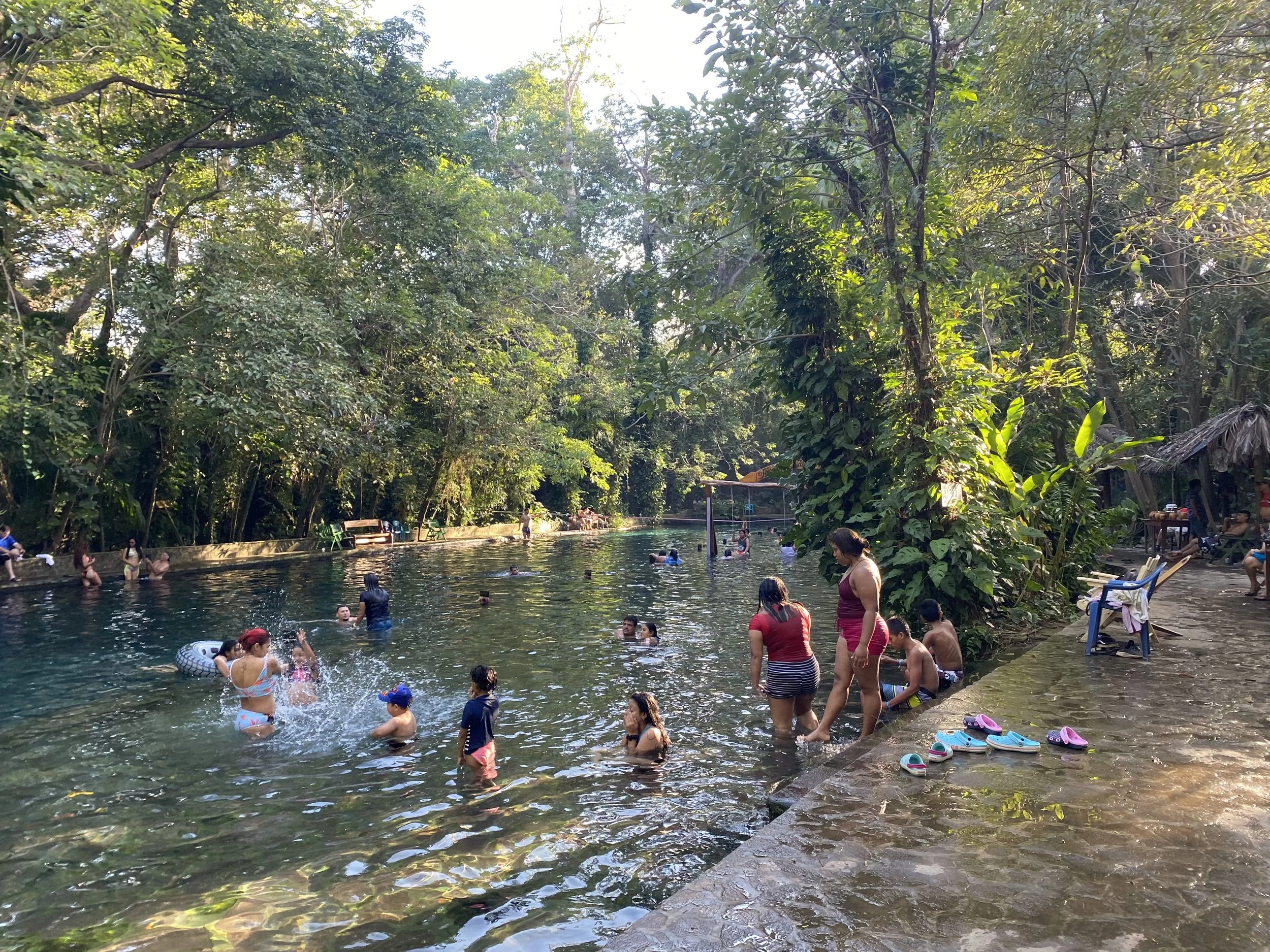 Ojo de Agua natural spring in Ometepe, Nicaragua with people swimming in a jungle setting