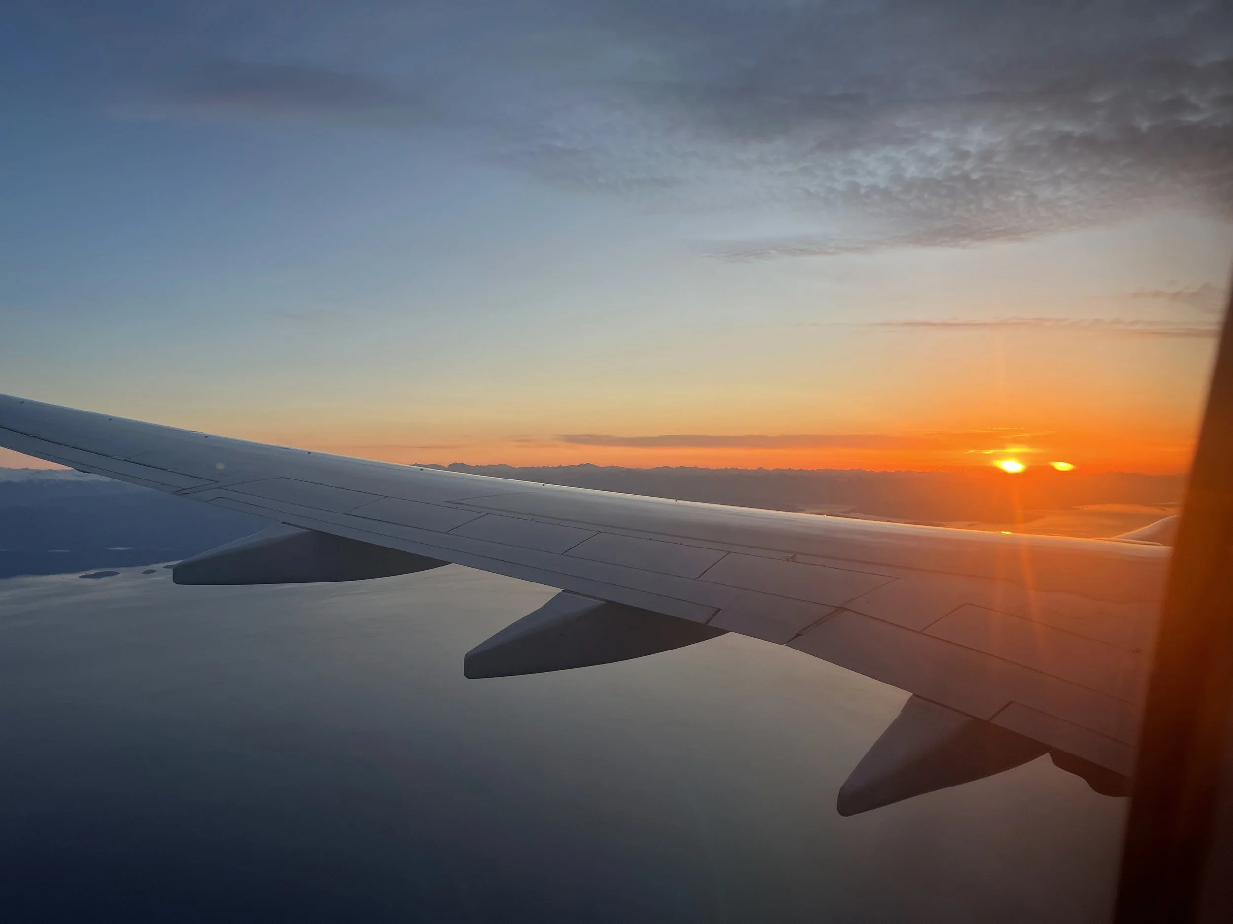 airplane wing sunset view during flight travel