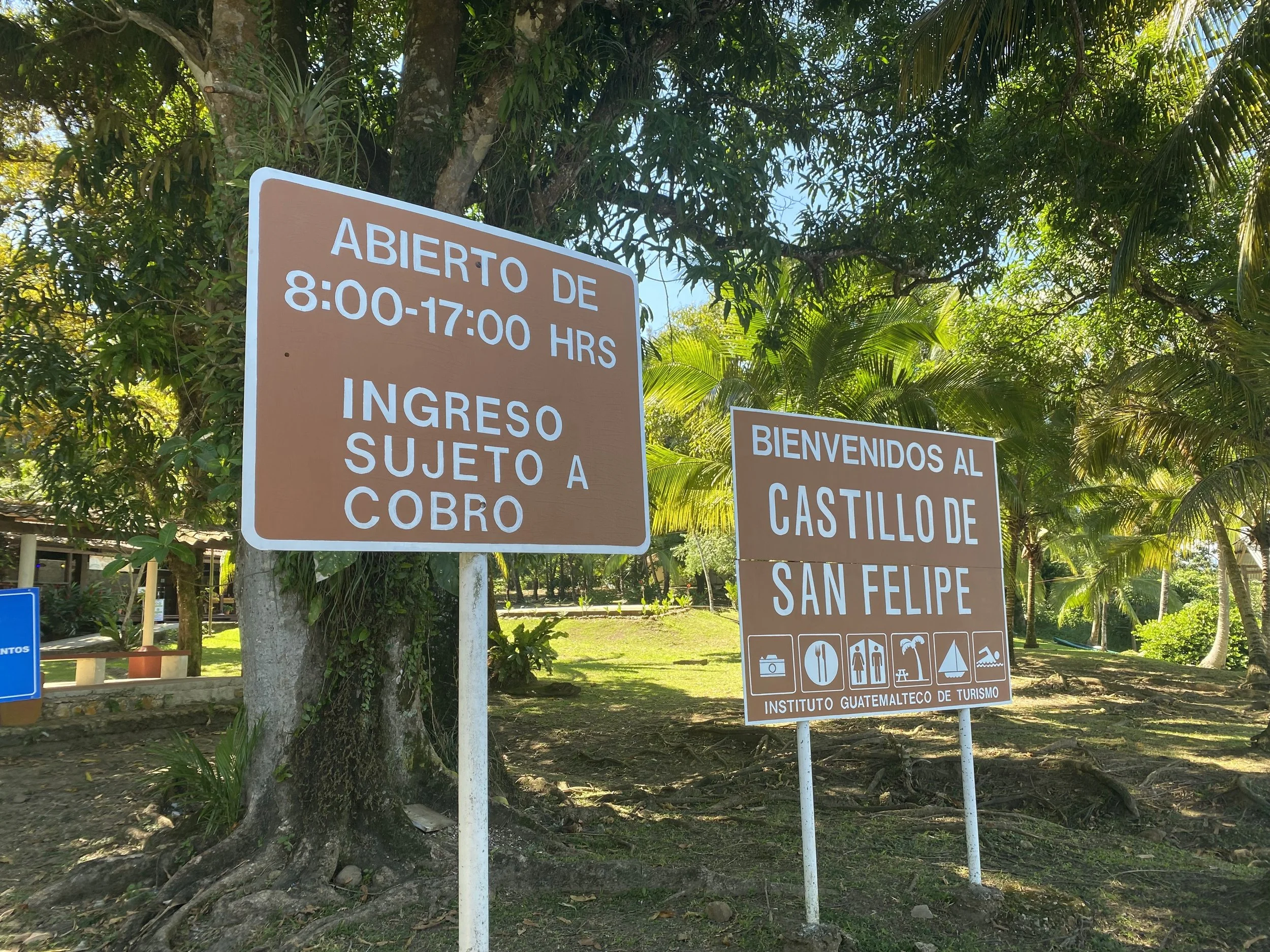 Spanish welcome signs at Castillo de San Felipe in Guatemala, highlighting the importance of learning basic local language while traveling.