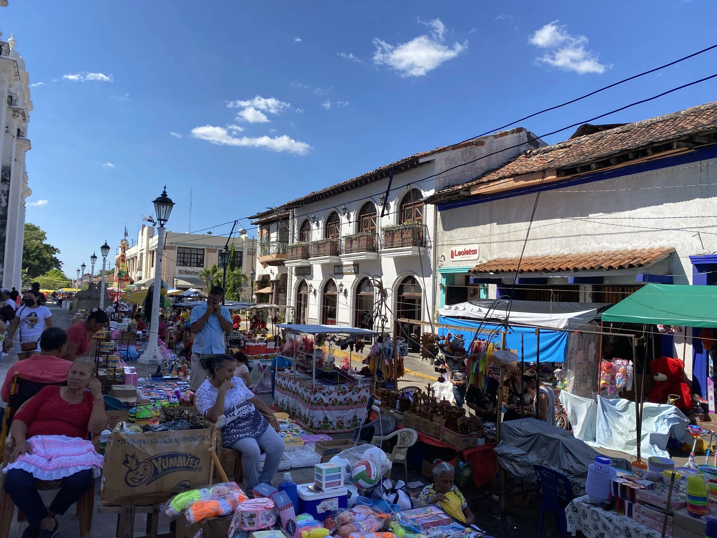 Busy local market in León Nicaragua with vendors, stalls, and people
