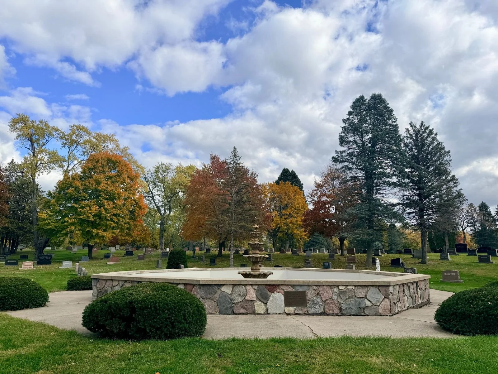 Fountain surrounded by trees in the cemetery grounds