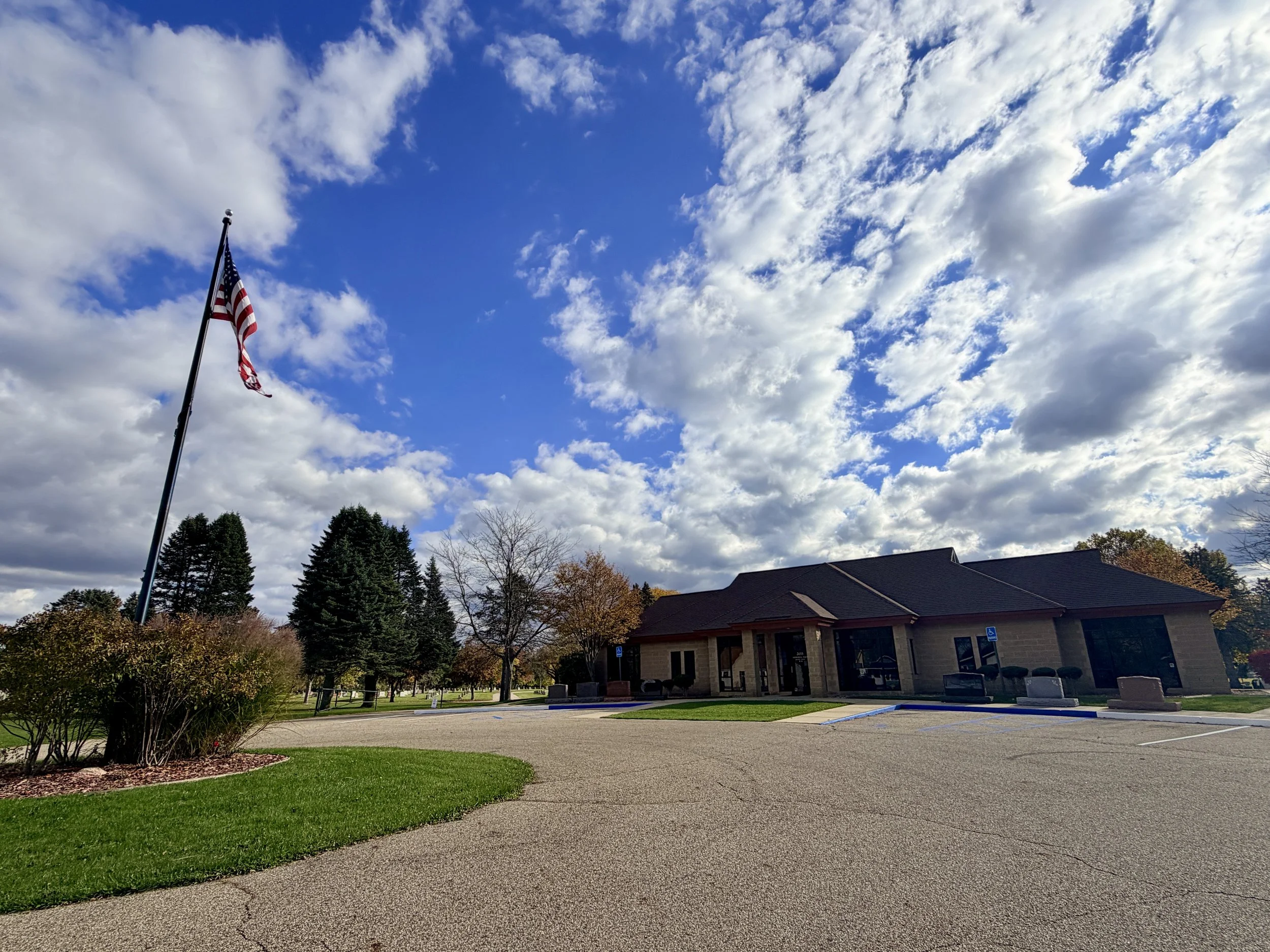 Entrance building at Battle Creek Memorial Park with American flag