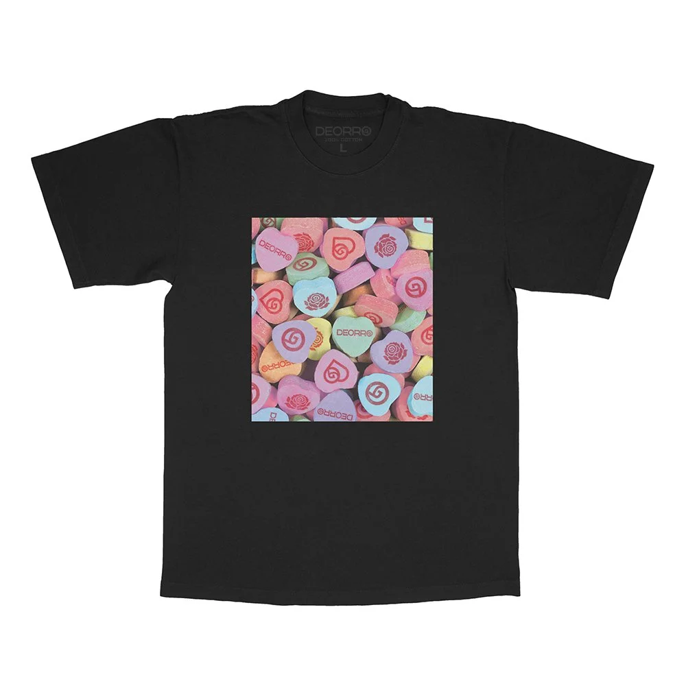 Black T-shirt with a colorful printed image of assorted pastel candies or tablets.