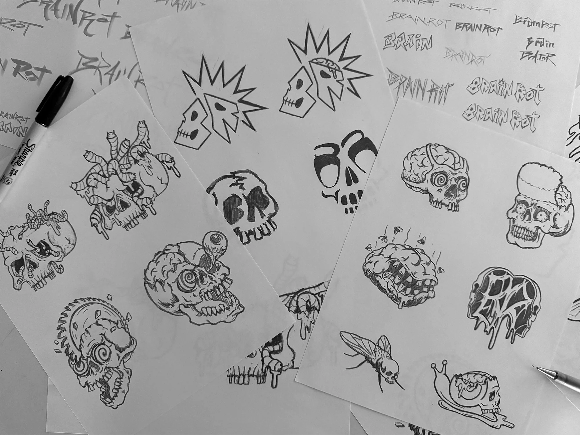 Sketches of skulls, some with decorative elements, along with various stylized text and logos, including the words "BRAIN ROT" and "BRAIN".