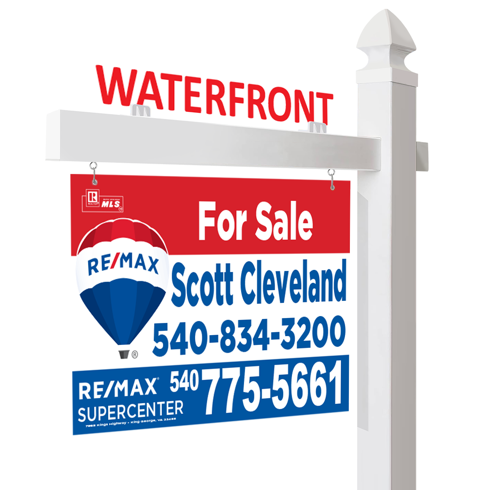 An aluminum real estate for sale sign for a waterfront property, with contact information for Scott Cleveland at RE/MAX Supercenter. The sign is hanging from a sign post and has a rider with it.