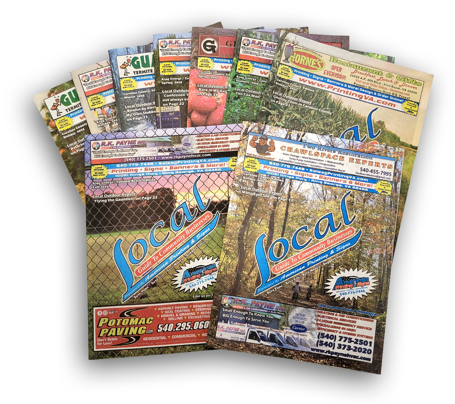 Several past issues of the Local Guide to Community Businesses advertising magazines stacked on top of each other.