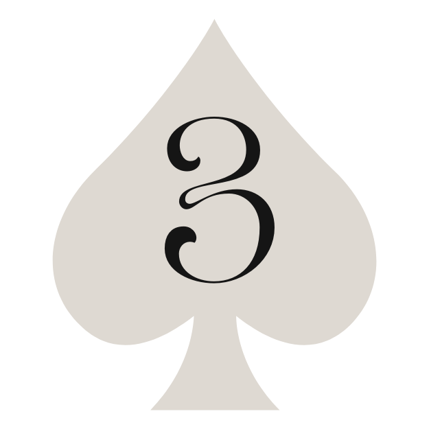 Modern house with wooden exterior walls and large glass window, situated in a mountainous landscape with grassy foreground and rugged hills in the background.