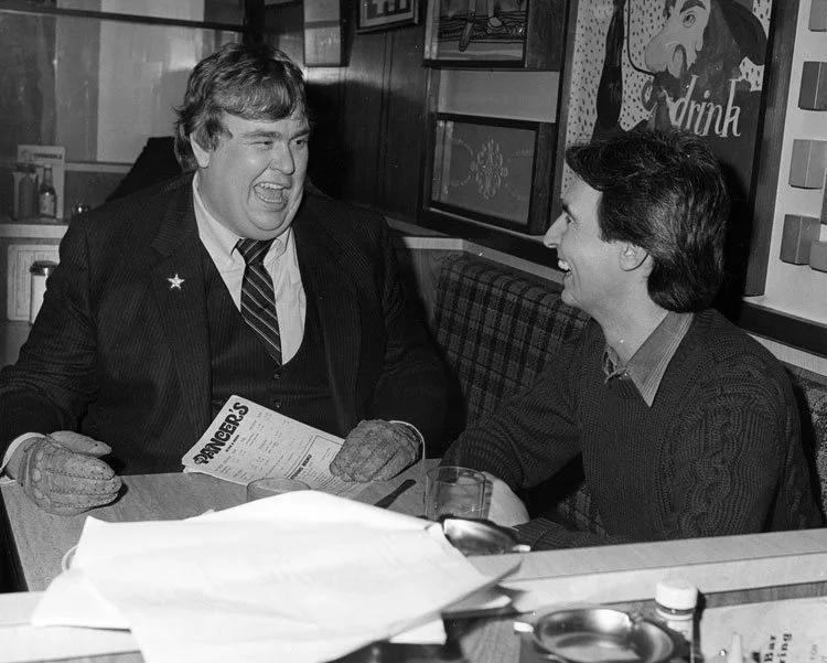 John Candy sits with David