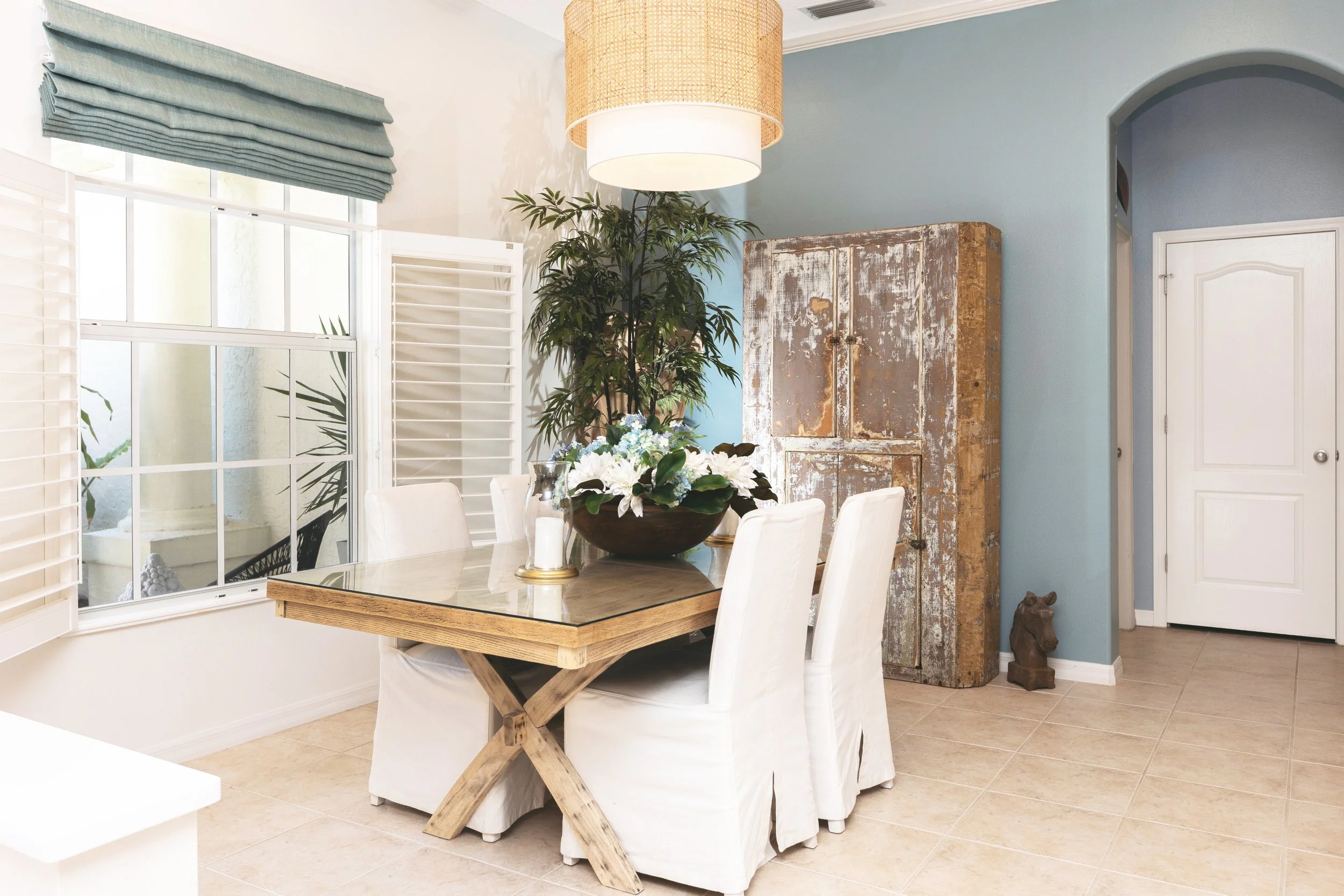 After photo of dining room interior styling  with accent wall and statement lighting by  Kristen Jensen Kitt and Kaboodle Lakewood Ranch Florida
