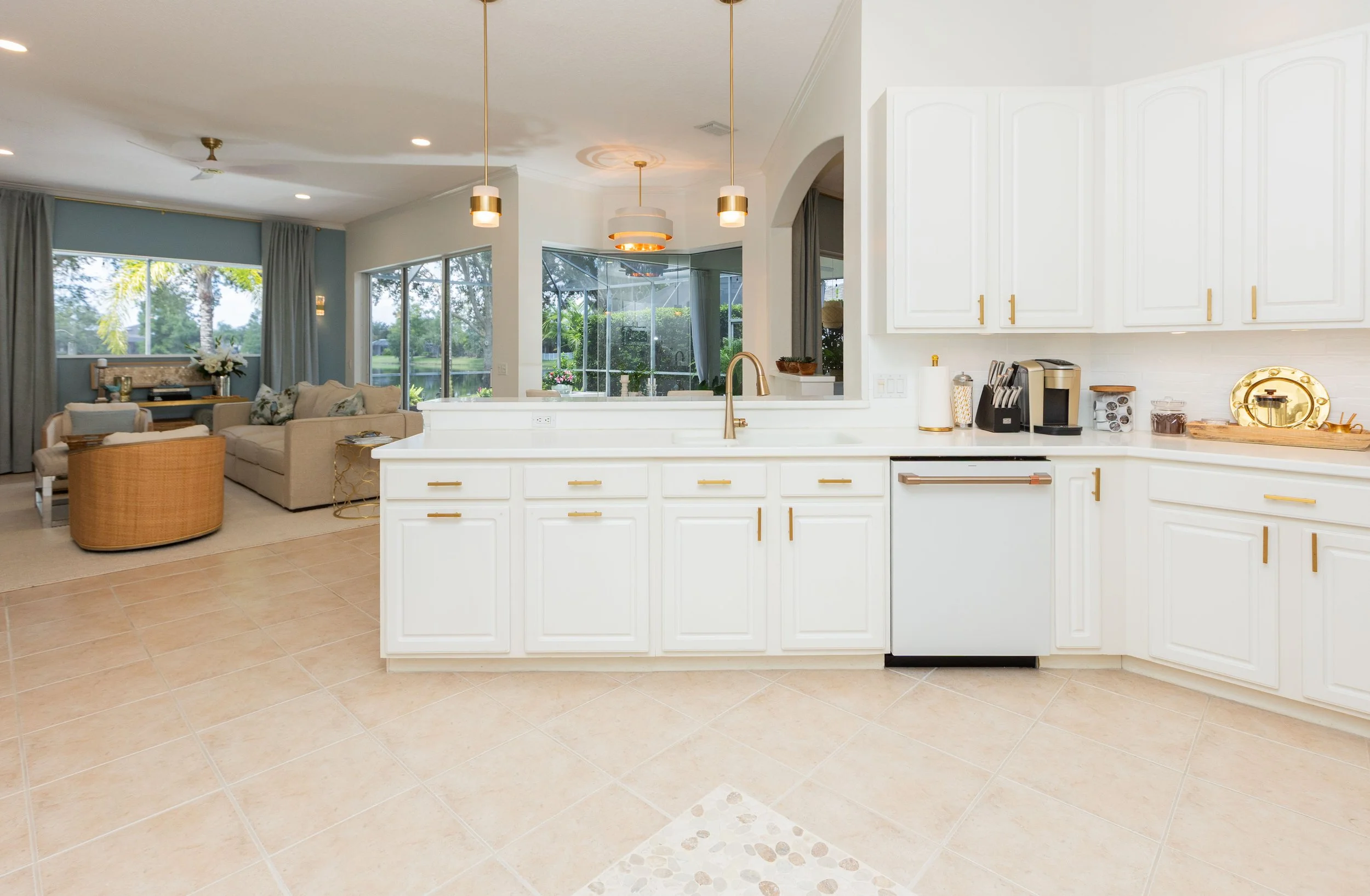 After photo of kitchen refresh with gold hardware  and pendant lighting by Tom Kitt and Kristen Jensen  Kitt and Kaboodle Lakewood Ranch Florida