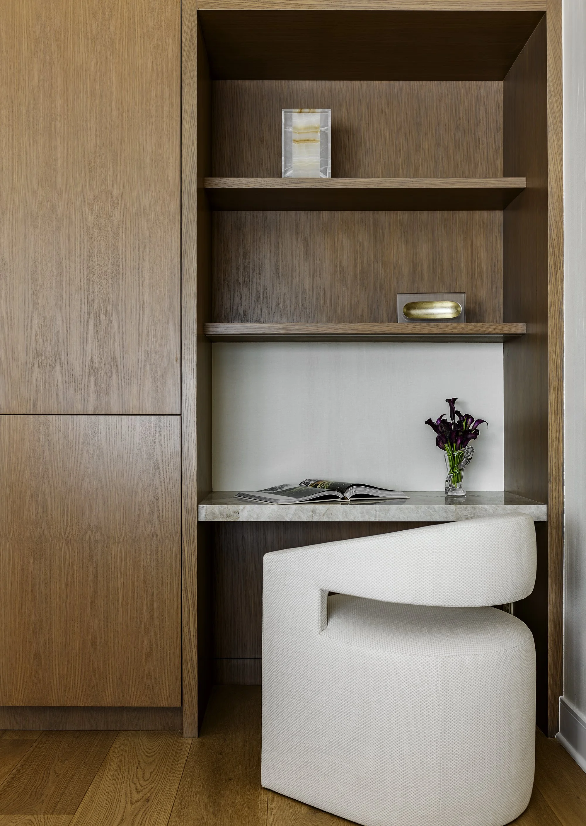 Interior architectural detailing with custom cabinetry, millwork, white oak, taj mahal countertop, magnetic wallcovering, holly hunt accessories and custom office chair from A.Rudin. Bespoke and timeless interiors.