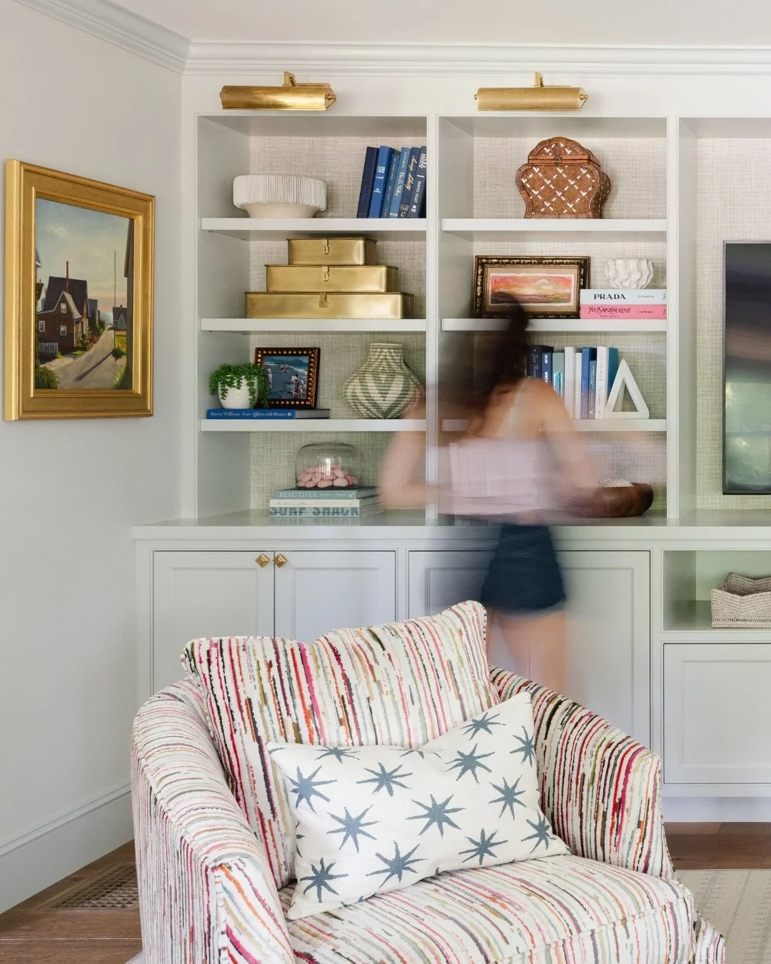 Designed from the very beginning with Honey and Fitz Interiors, this beach house living room was thoughtfully planned to feel layered, functional, and timeless. Pale blue walls, trim, and custom-built-in millwork create a soft architectural foundatio