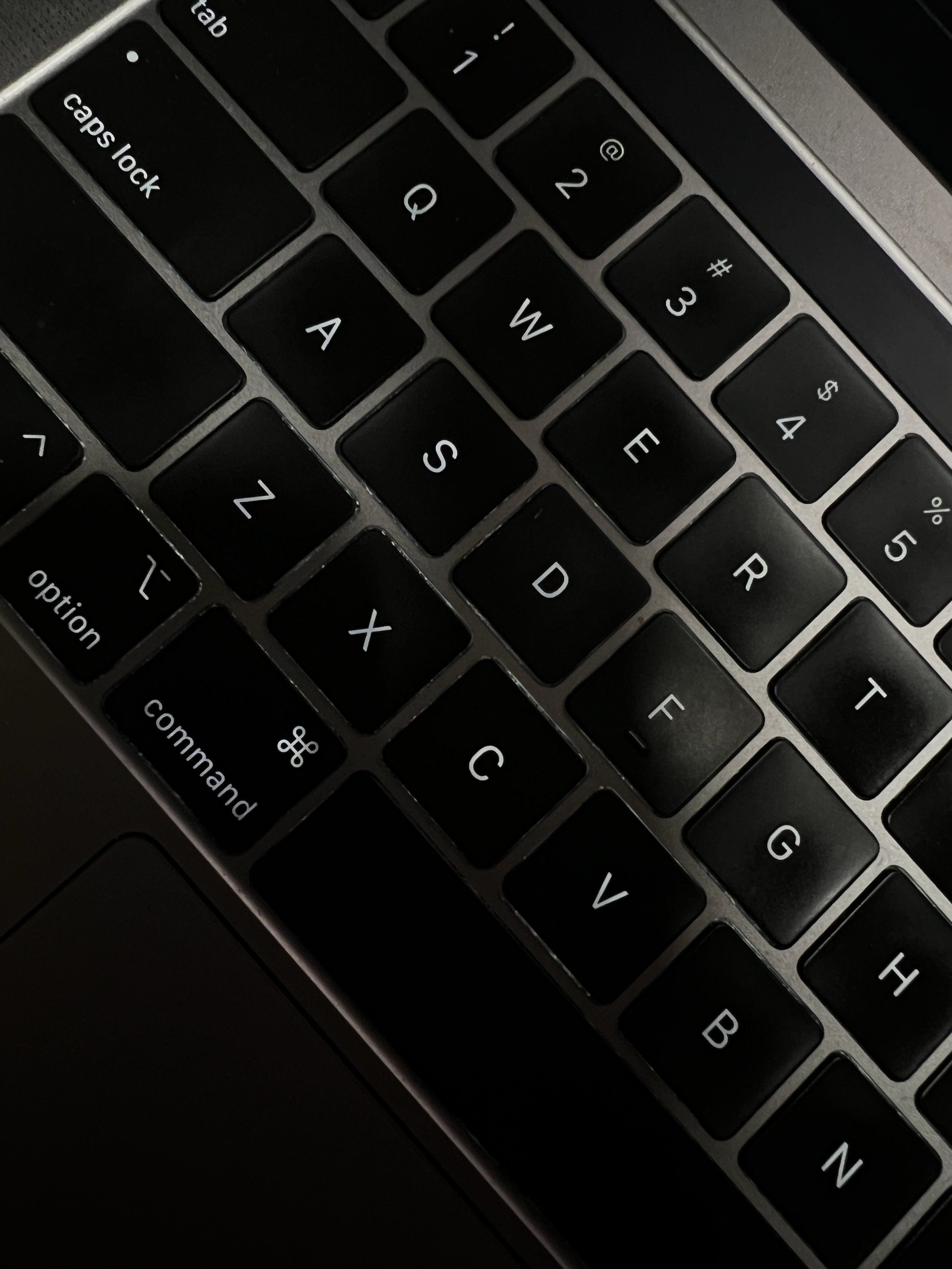 Close-up of a laptop keyboard, representing hands-on work with AI tools in a small business