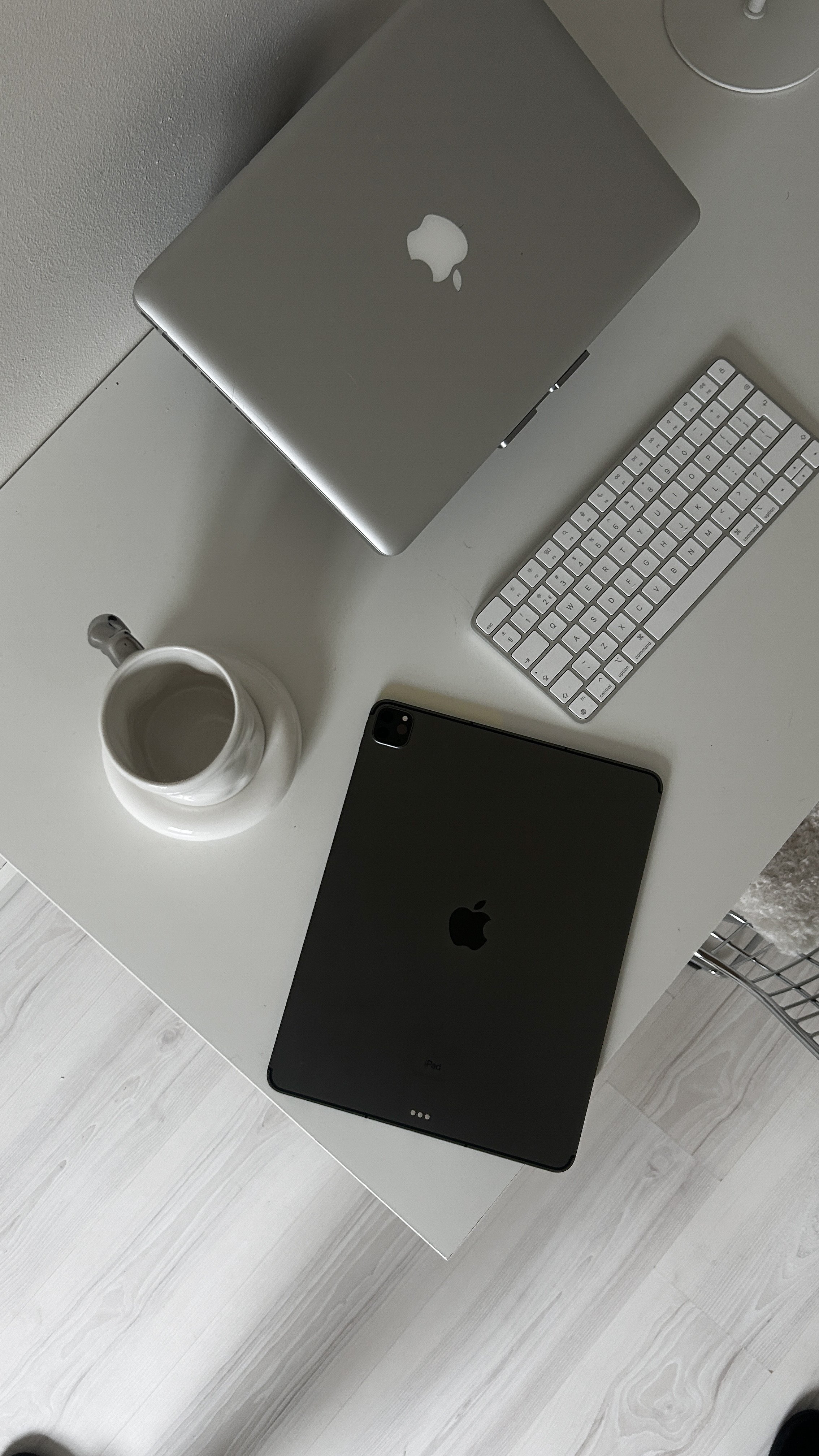 Desk workspace with laptop, iPad and keyboard used for digital marketing work