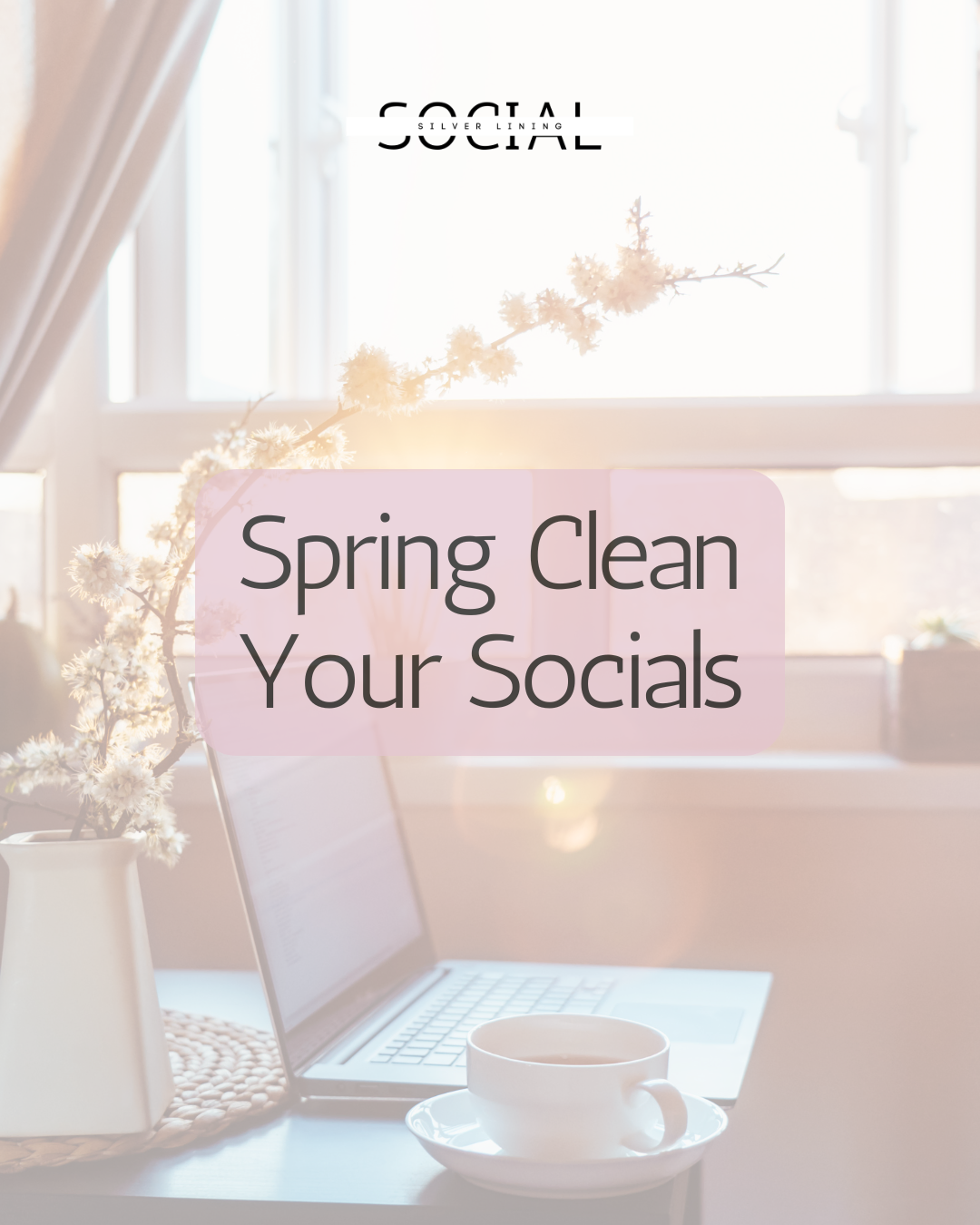 Laptop and cup of tea on a desk with spring flowers — spring clean your social media guide by Silver Lining Social
