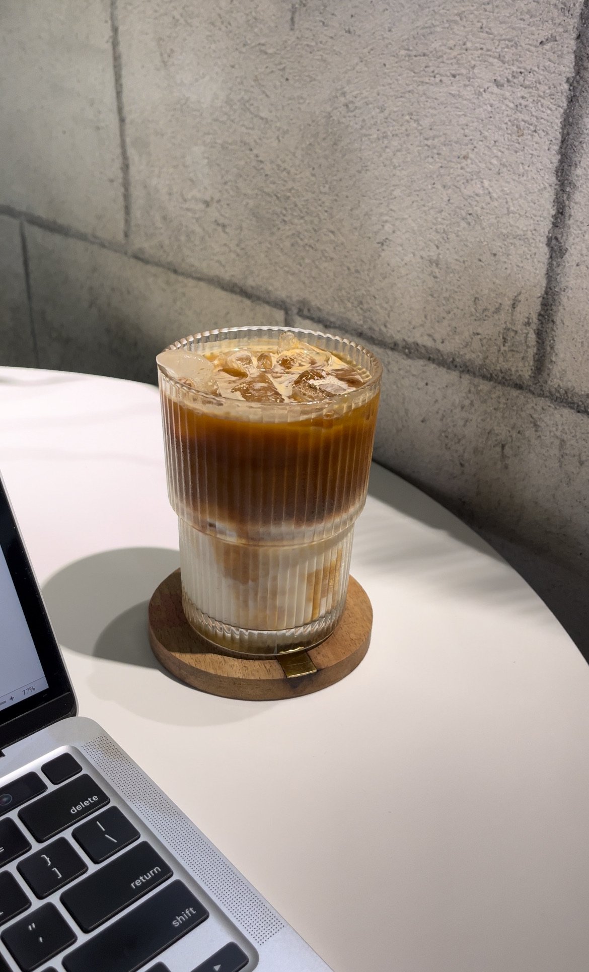 Laptop and iced drink on a café table while working on Google Business Profile marketing