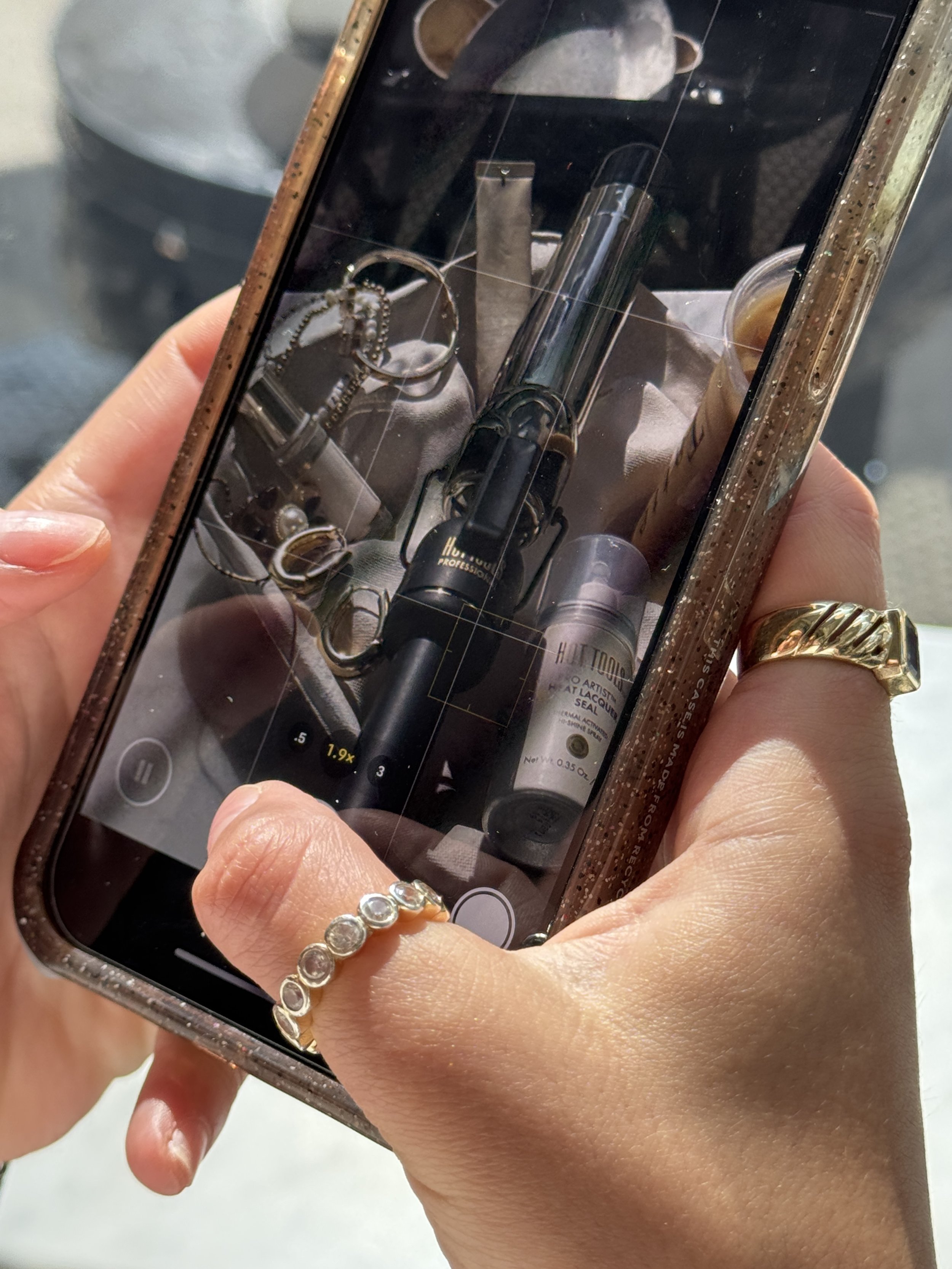 Small business owner photographing jewellery and beauty products on a smartphone for social media content