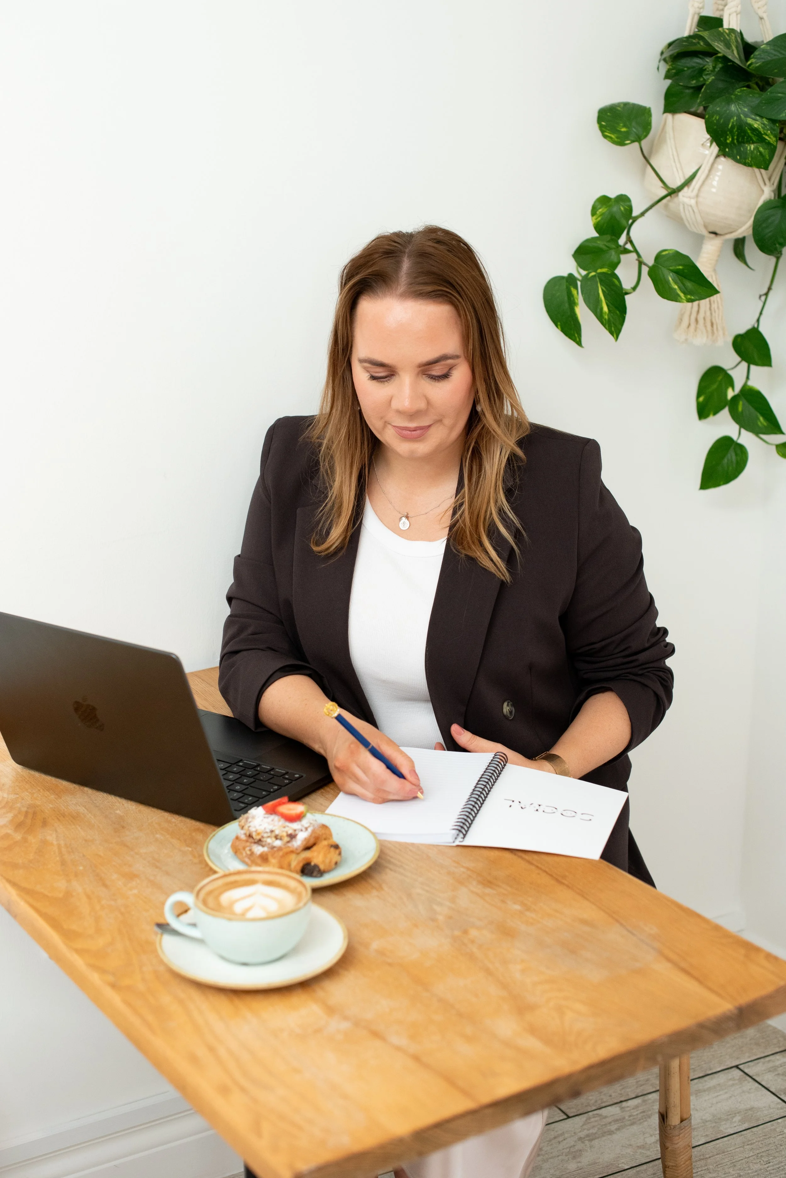 Grace from Silver Lining Social writing notes while working on a digital marketing plan