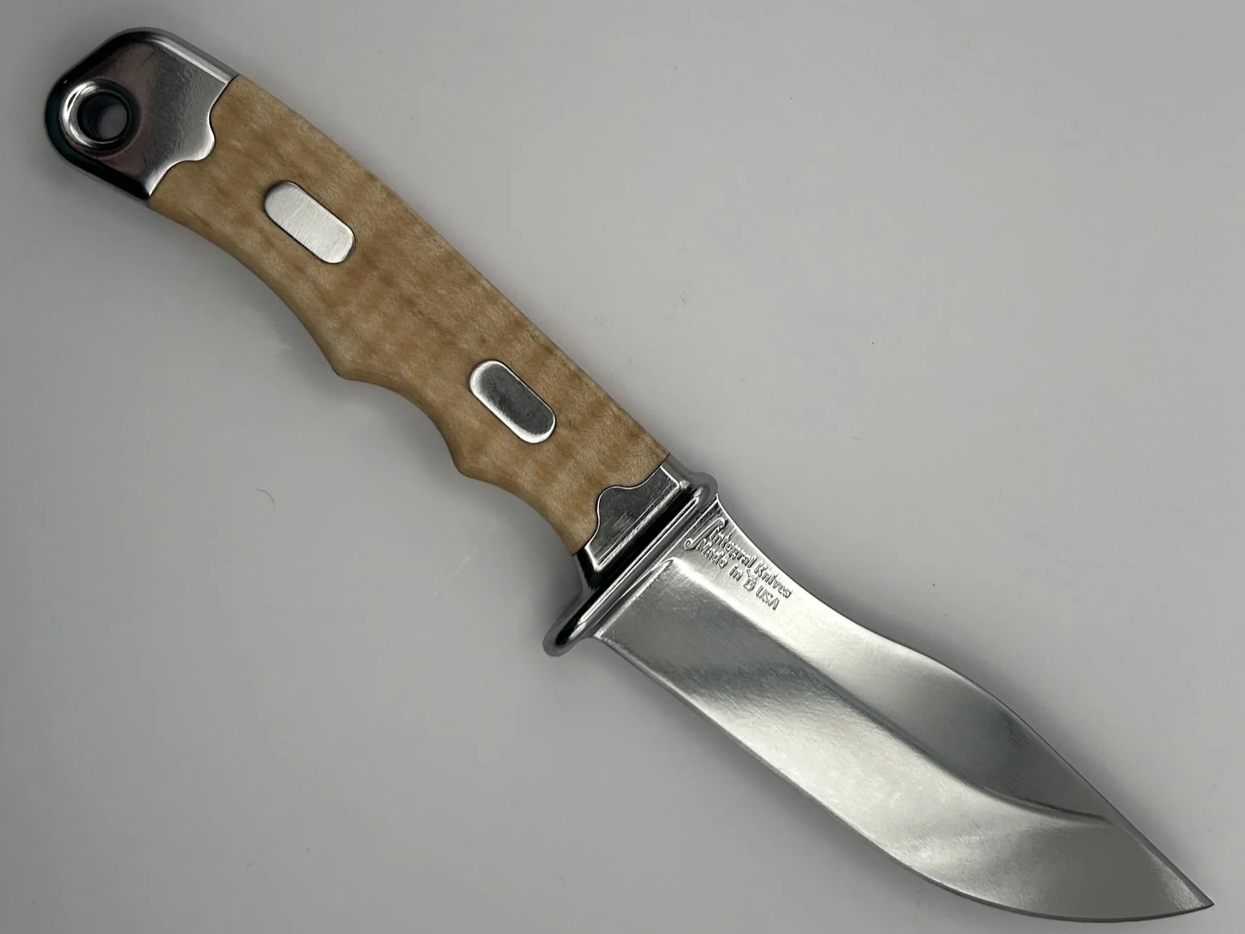 A fixed-blade hunting knife with a D2 steel blade and a curly maple handle.