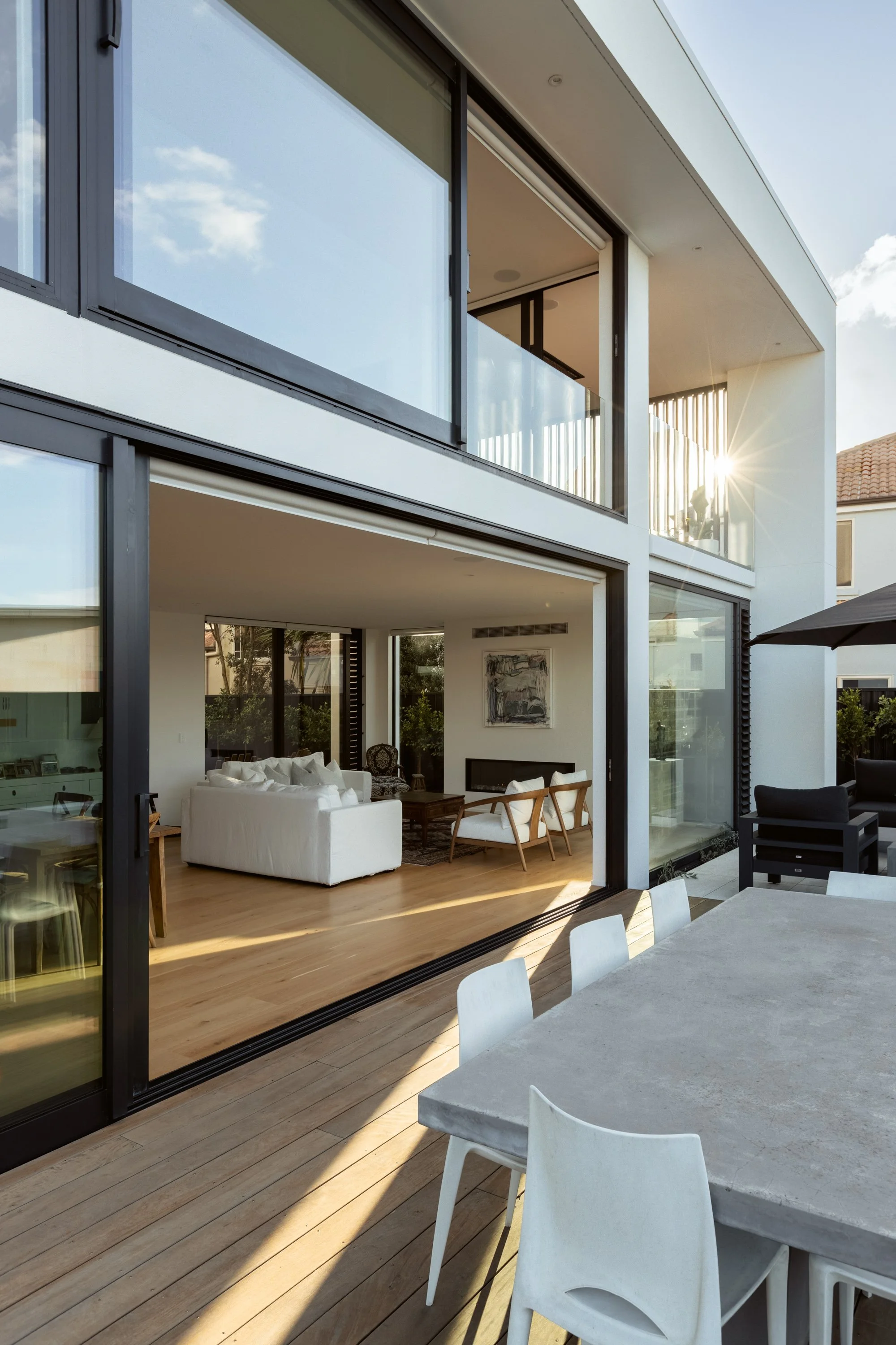 Outdoor living area of Beachside Minimalism Tauranga home with seamless indoor-outdoor connection