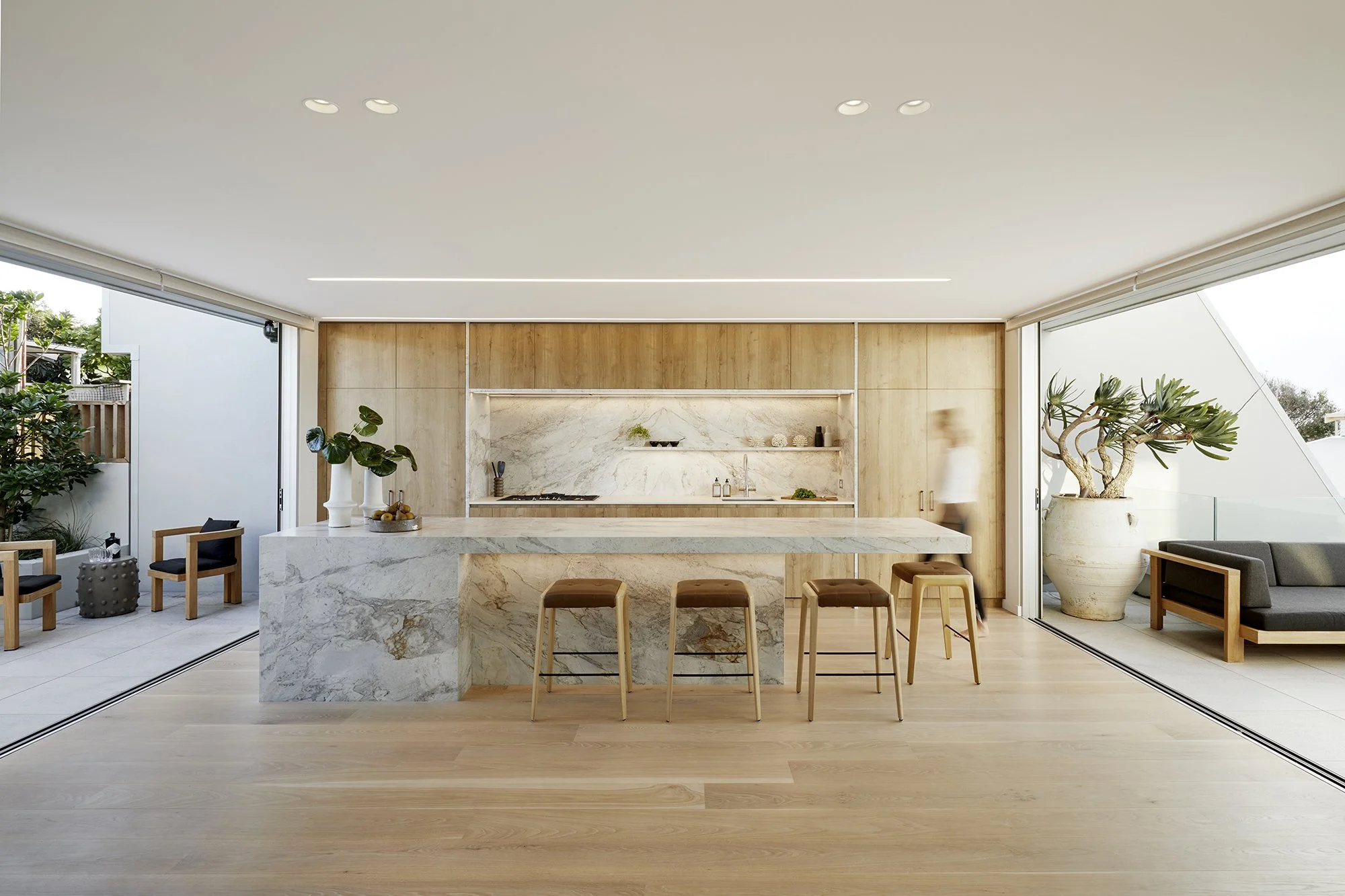 Kitchen in Surf’s Edge Tauranga home featuring natural material finishes and outdoor connections