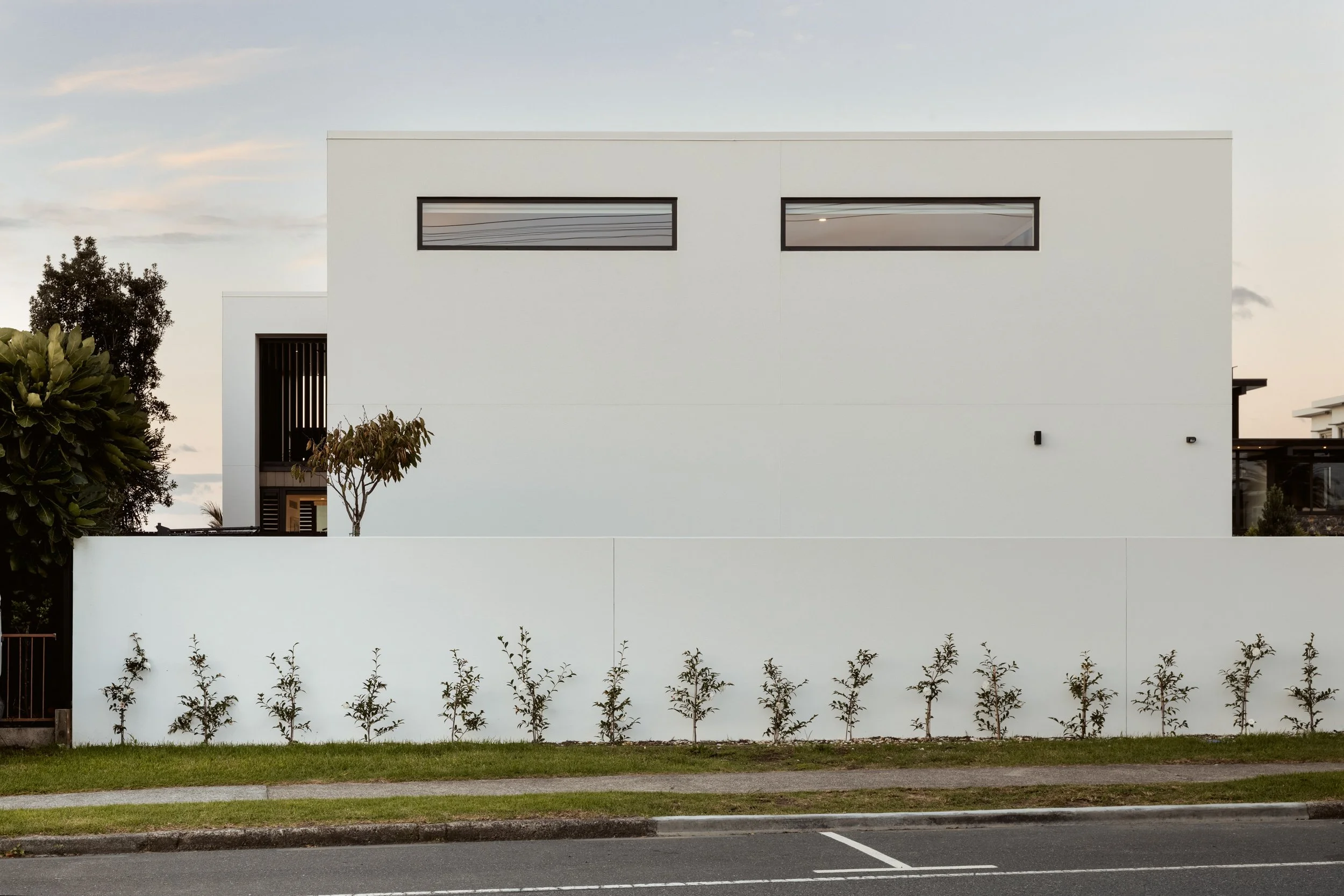 Roadside facade of Beachside Minimalism Tauranga home showcasing minimalist coastal design