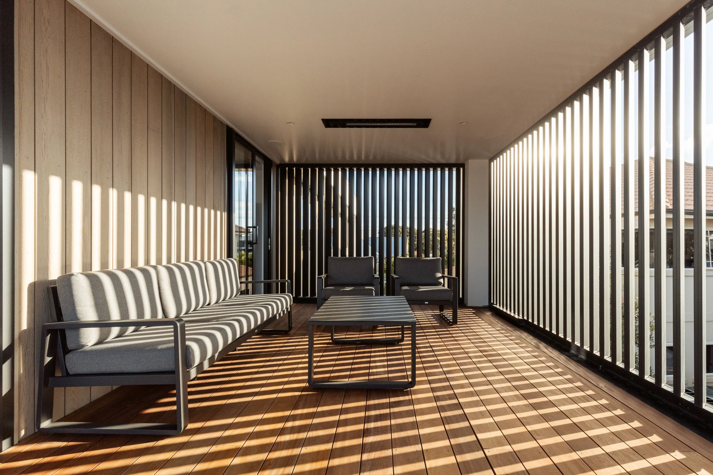 Outdoor living area of Beachside Minimalism Tauranga home with beach views and architectural louvres