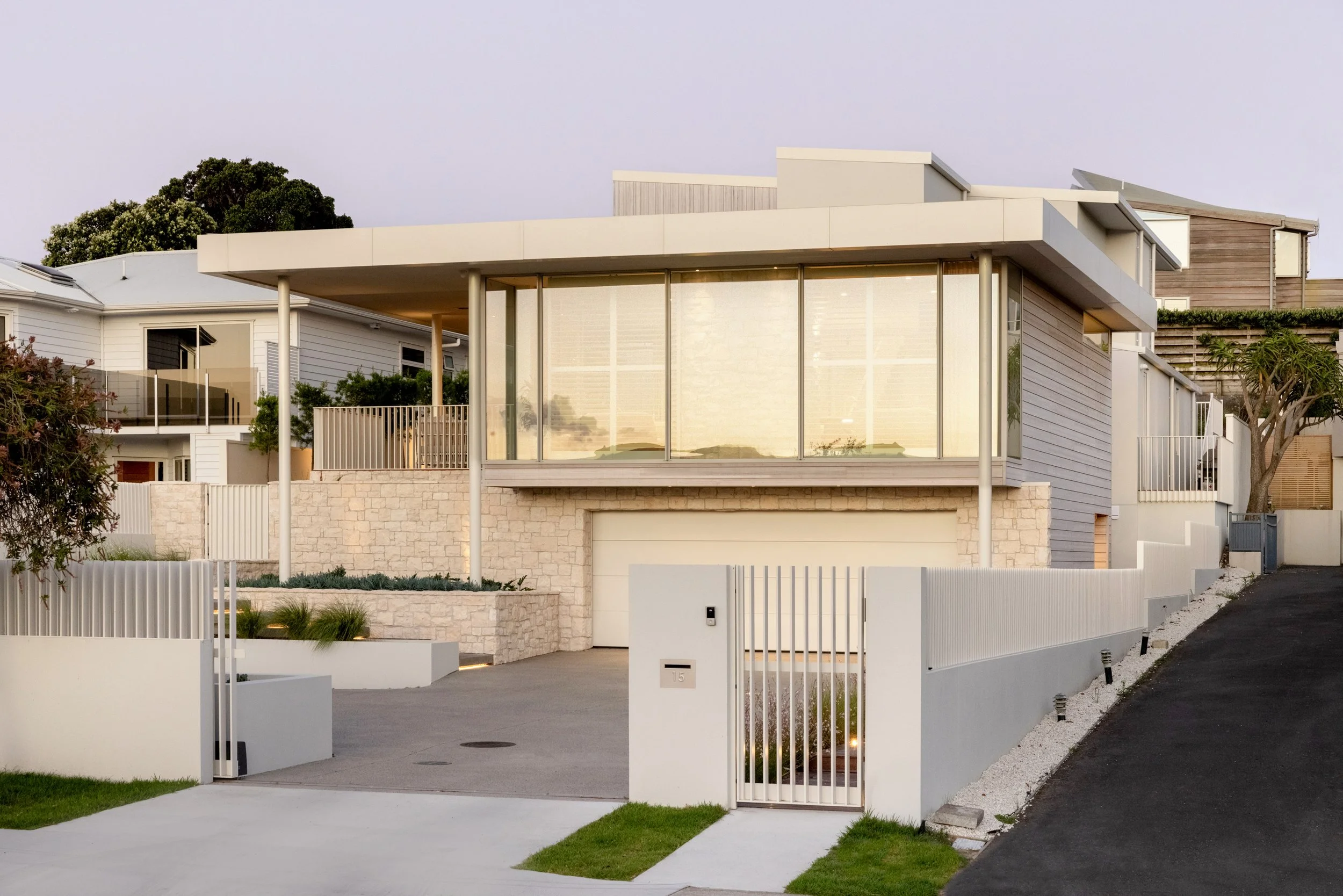 Roadside facade of Palm Springs Mount Maunganui home renovation with natural stone and timber