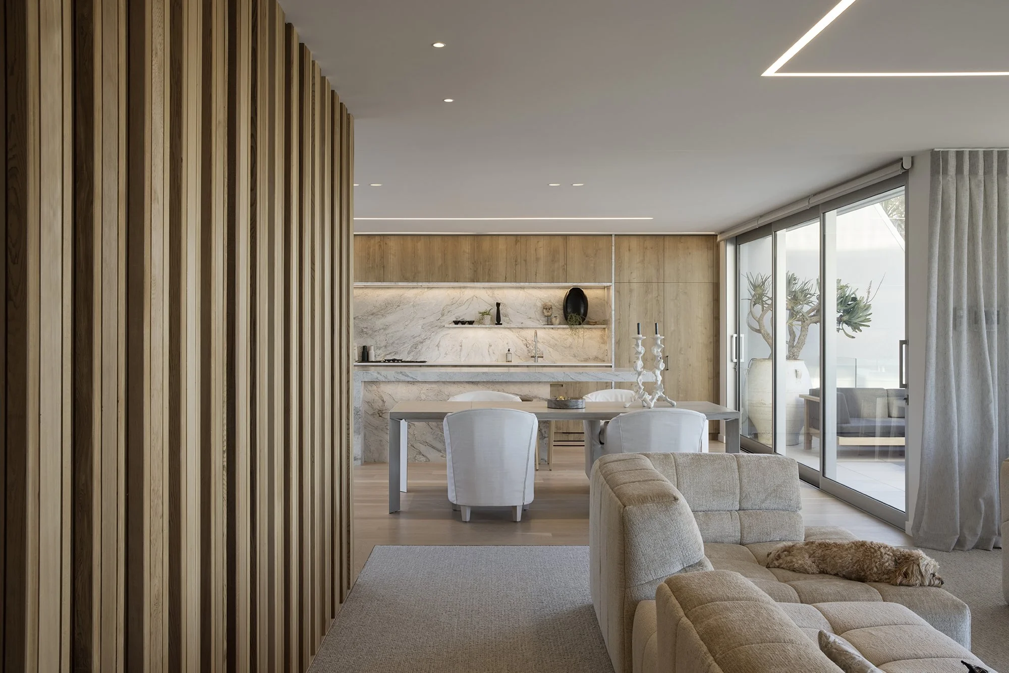 Open-plan living and dining area in Surf’s Edge Tauranga home with coastal views