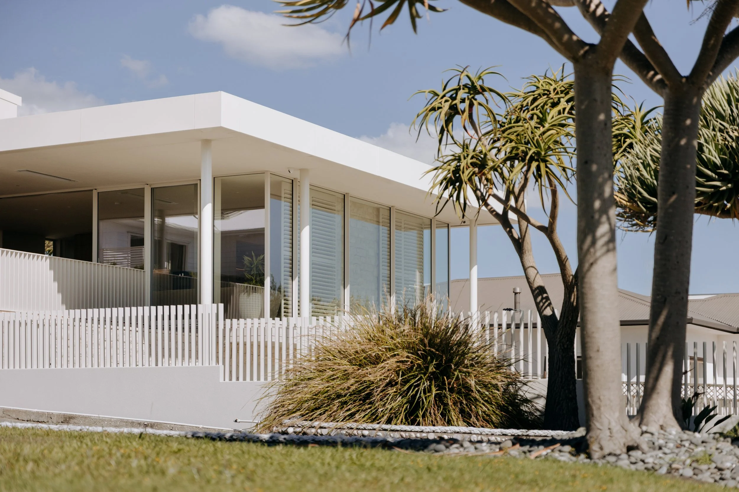 Side view of Palm Springs Mount Maunganui renovation showing flat roof and generous eaves