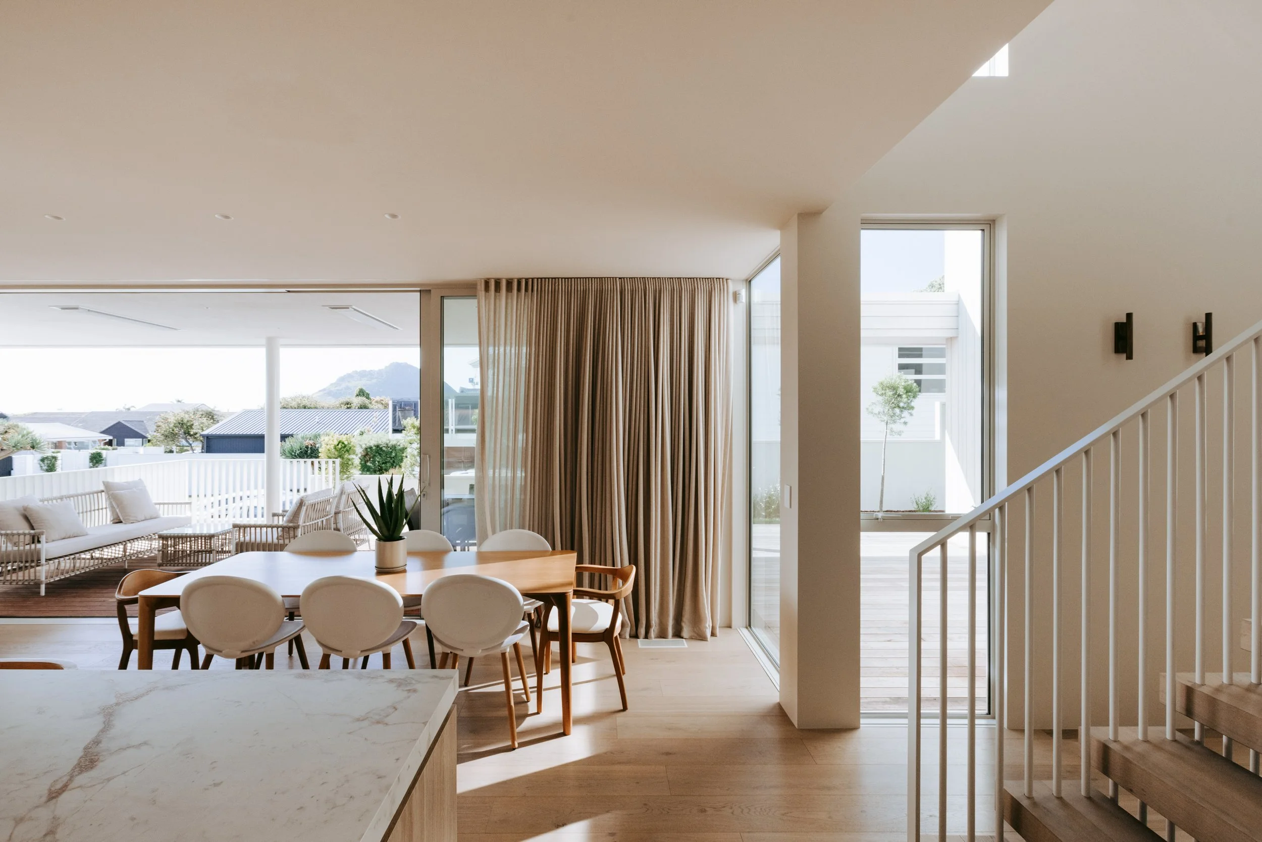 Dining area in Palm Springs Mount Maunganui home renovation with indoor-outdoor connection
