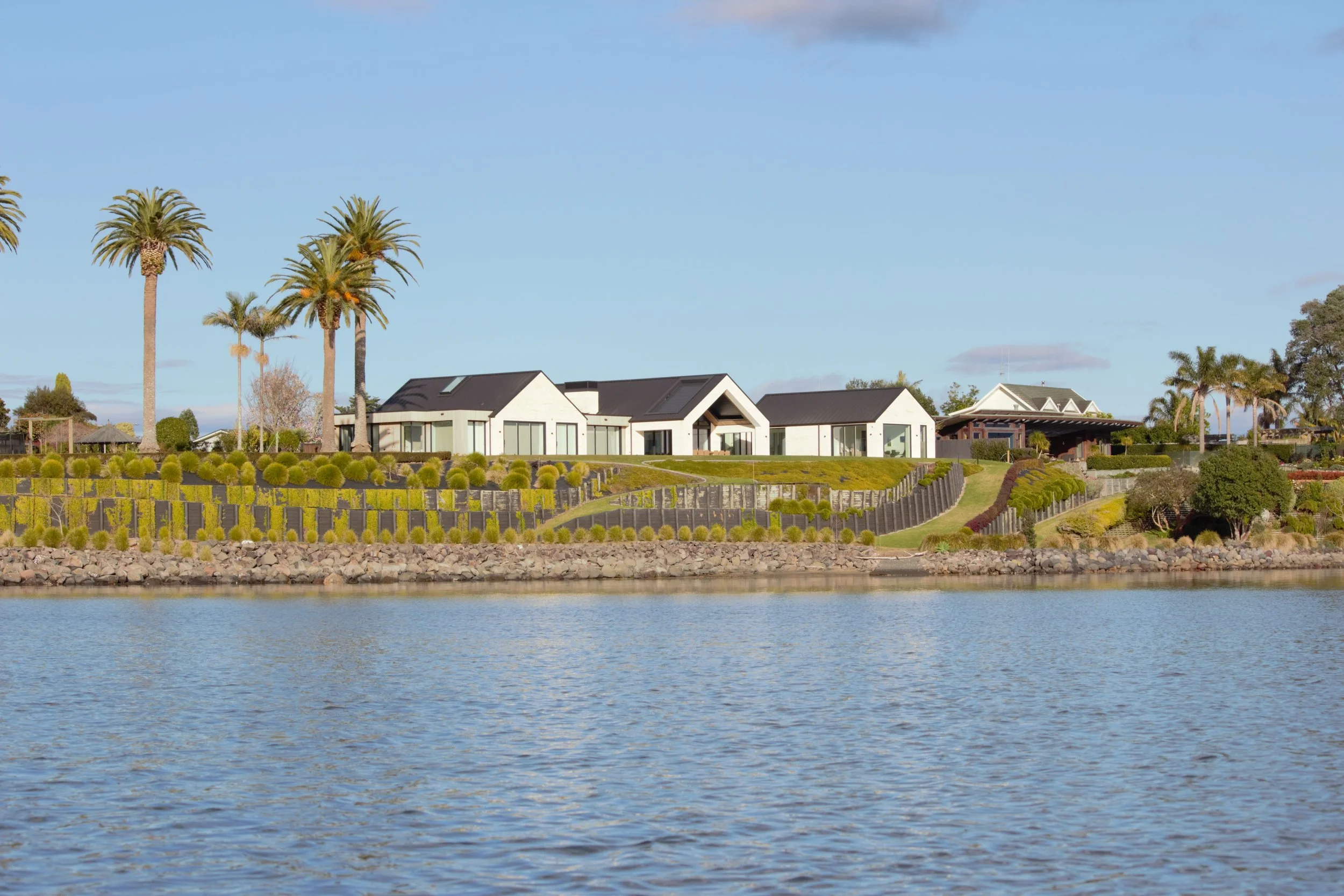 Water view of Harbour View home in Tauranga with natural stone and timber cladding