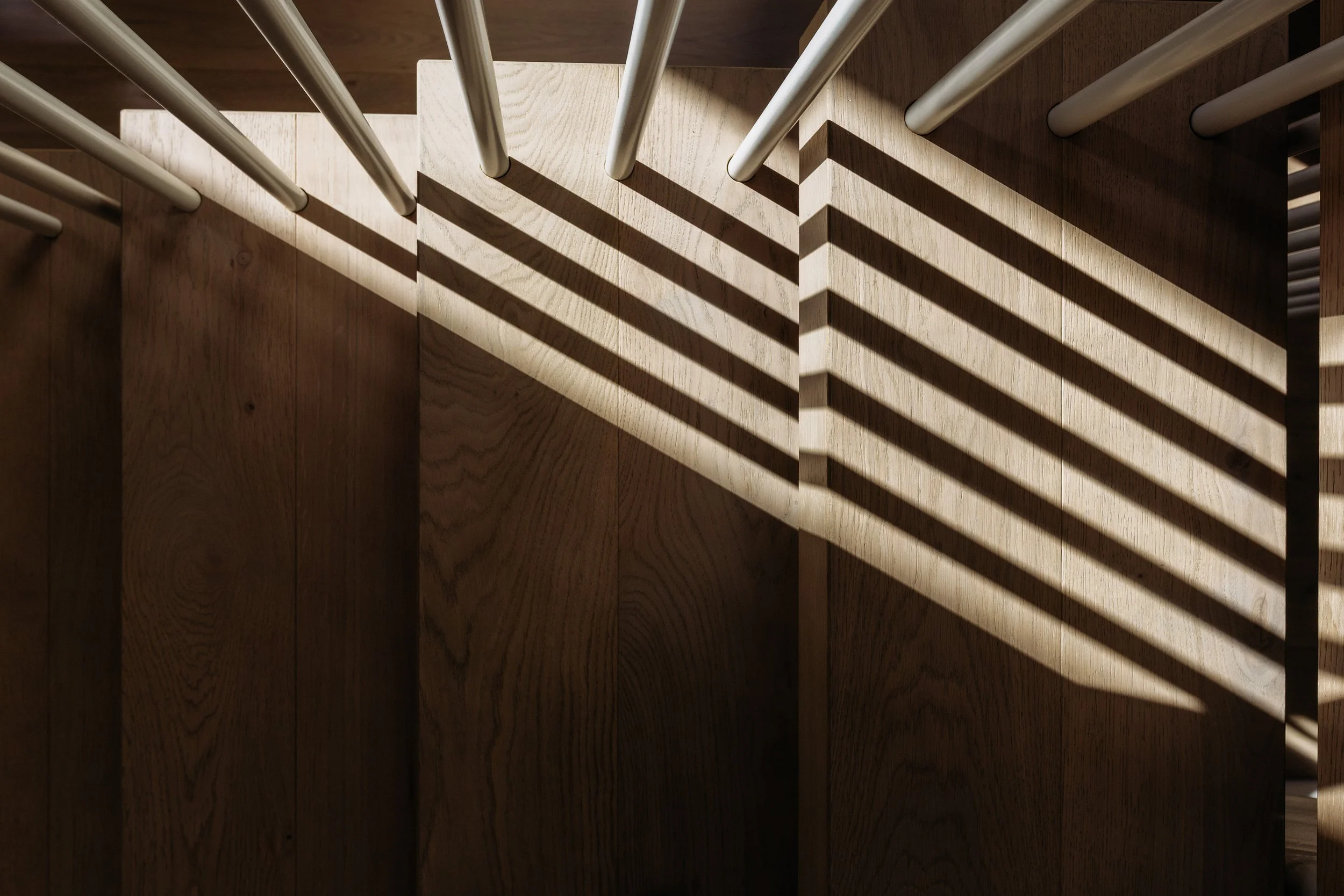 Interior stairs in Palm Springs Mount Maunganui home renovation with timber treads and decorative balustrade